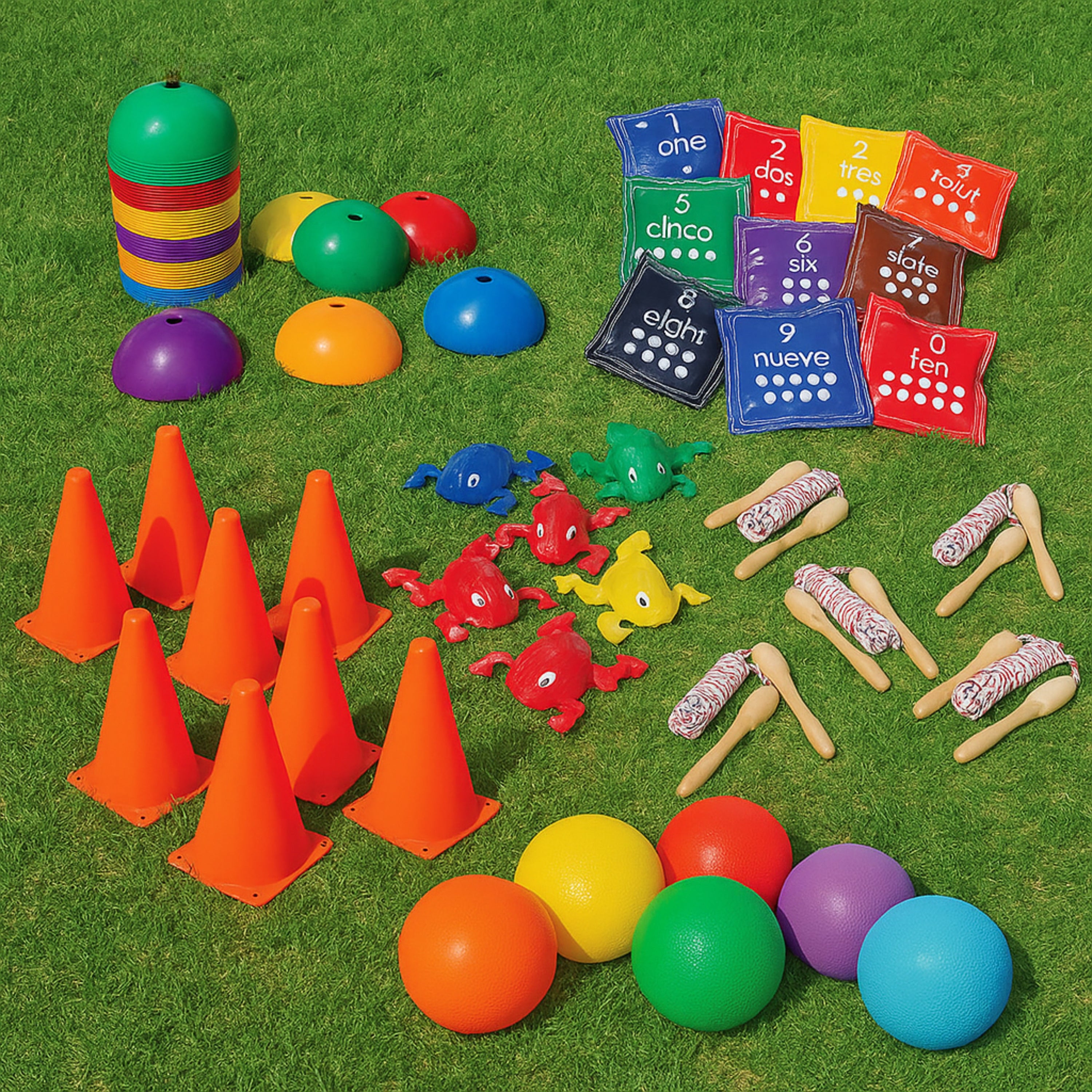 Colorful educational toys including traffic cones, balls, and number bean bags on a grassy background