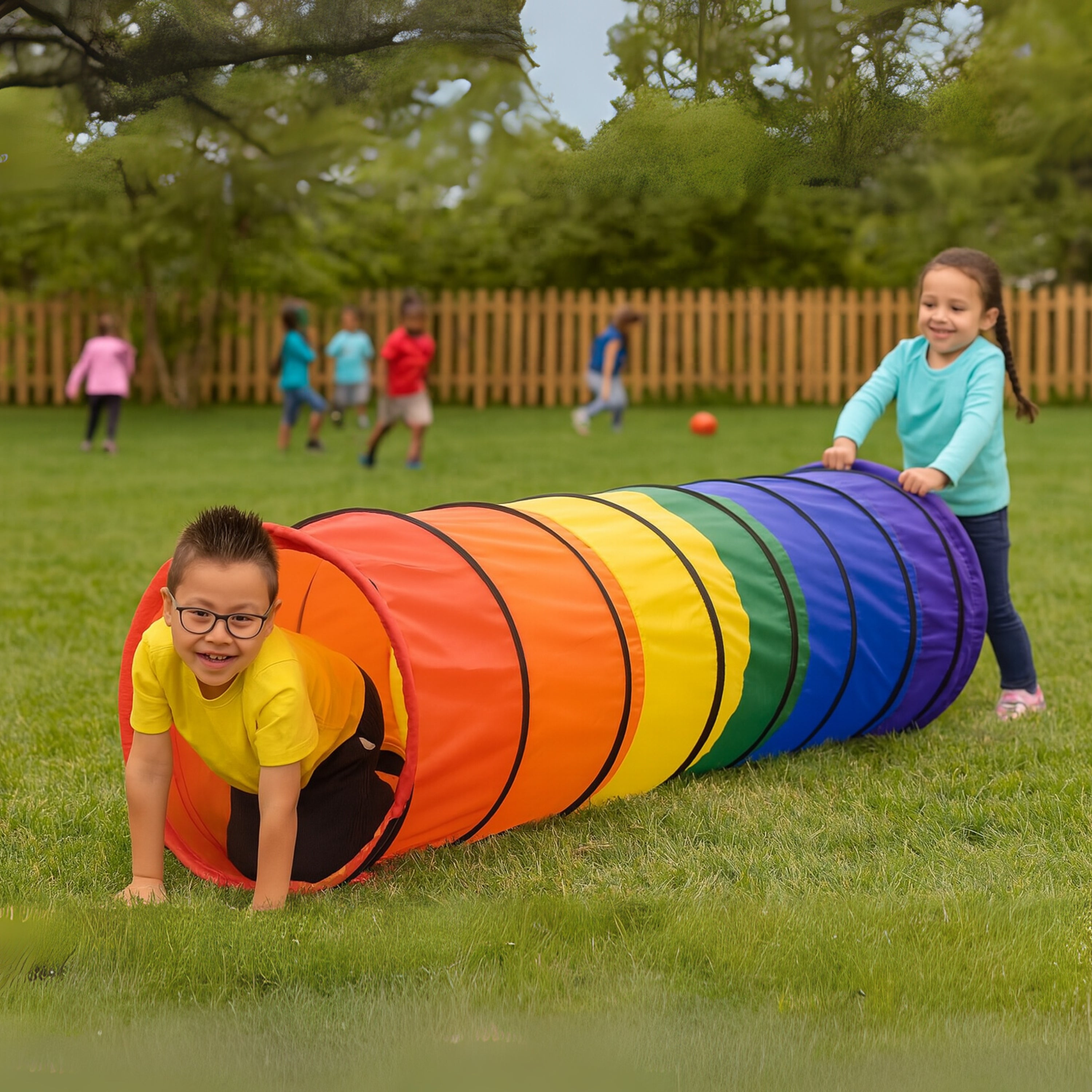 Children playing with a colorful tunnel in a grassy area.