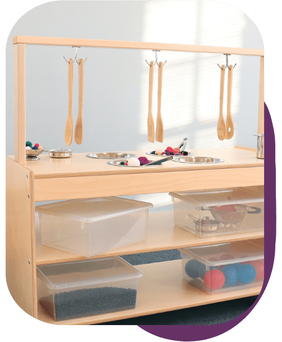 mobile sensory kitchen with various containers of materials on the open shelves