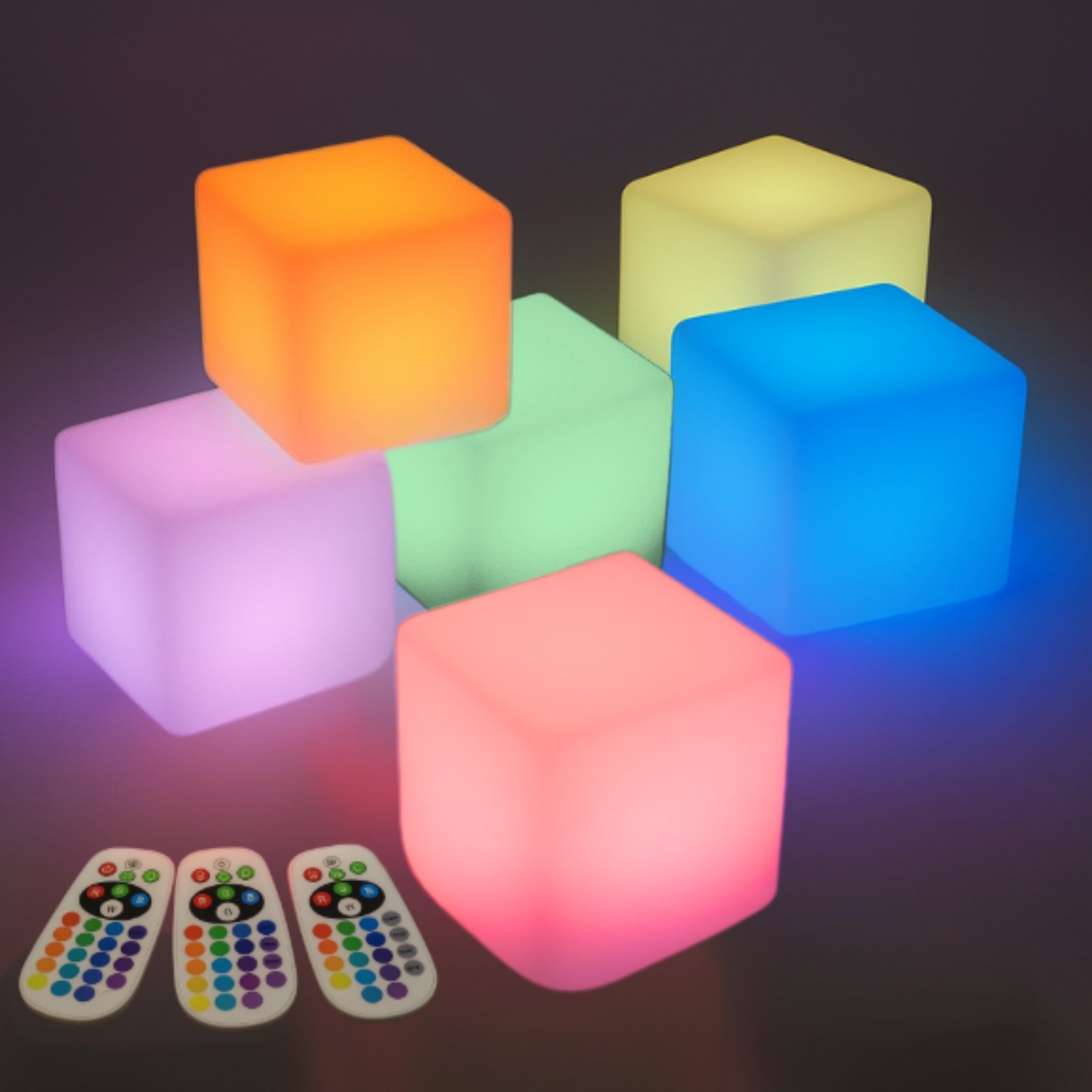 Colorful illuminated cubes with remote controls on a dark background
