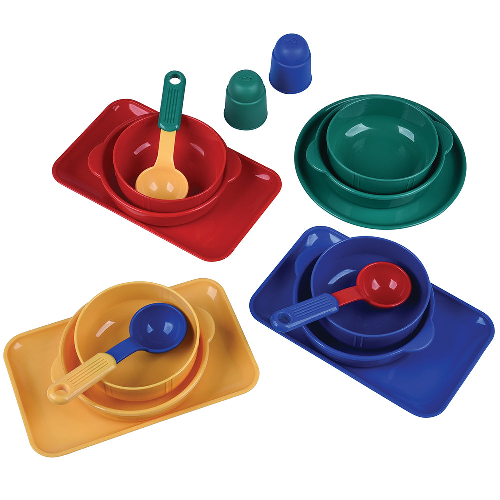 Set of colorful plastic dishes and spoons on a white background