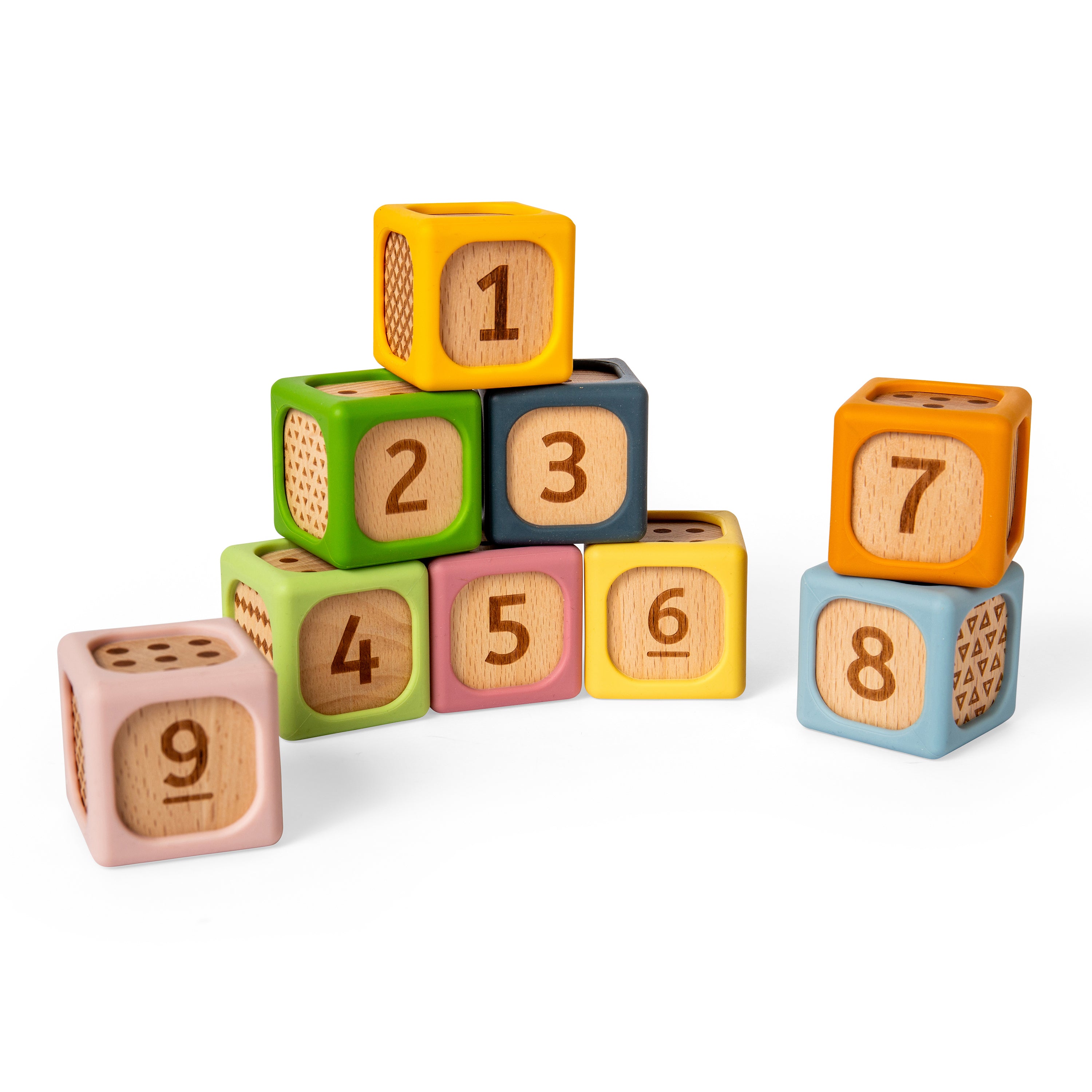 A set of colorful wooden number blocks arranged in a small pyramid on a white background. The blocks are pastel pink, green, blue, yellow, and lavender, each engraved with a number from 1 to 9, and some show dotted dice patterns on the side.