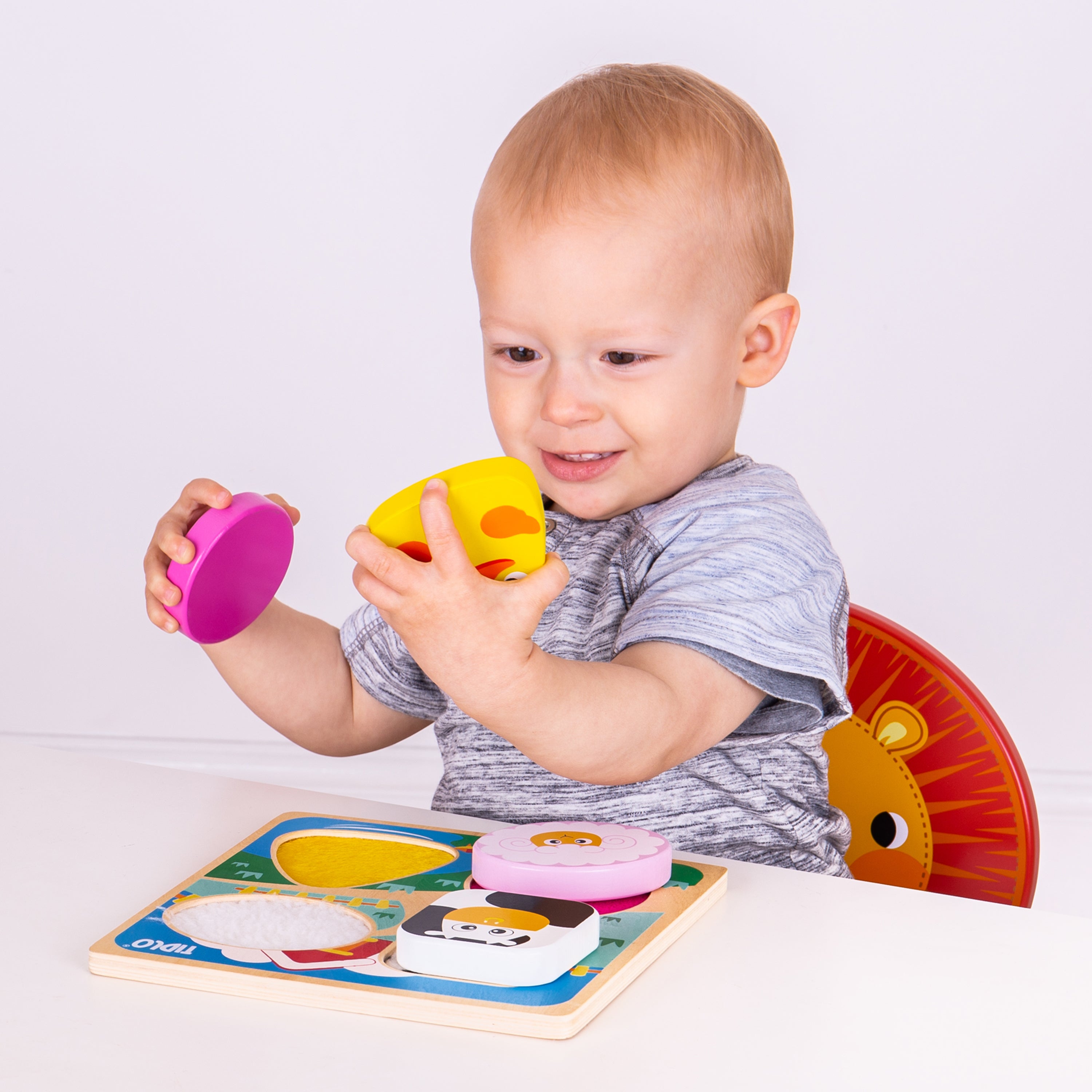 Child playing with colorful educational toys on a white background