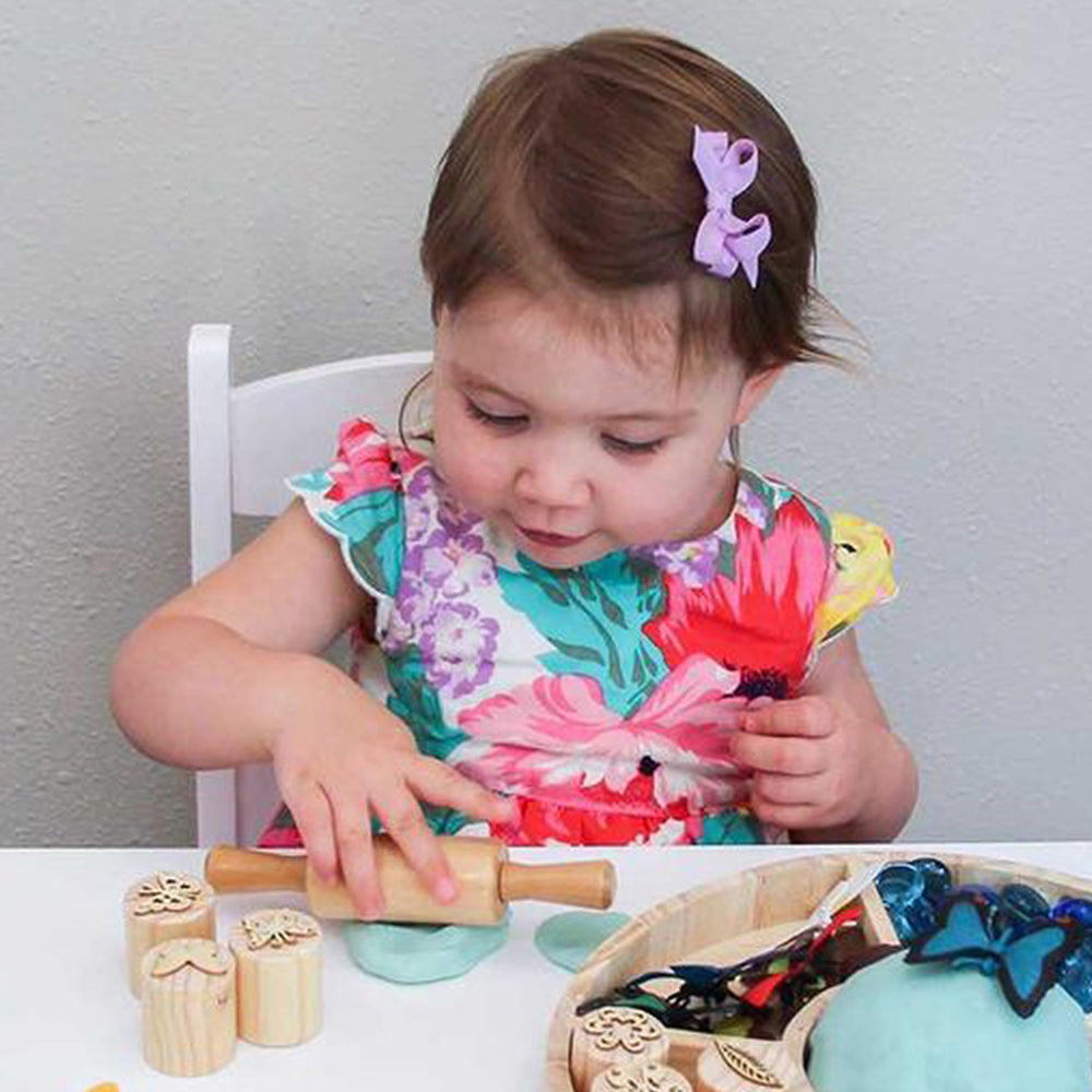 Child Rolling Play-Doh with Clay Impression Rollers