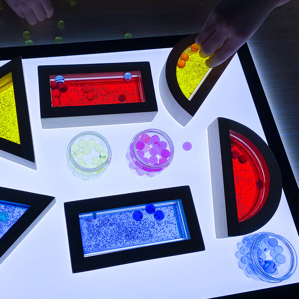 Close-up of water blocks on light table