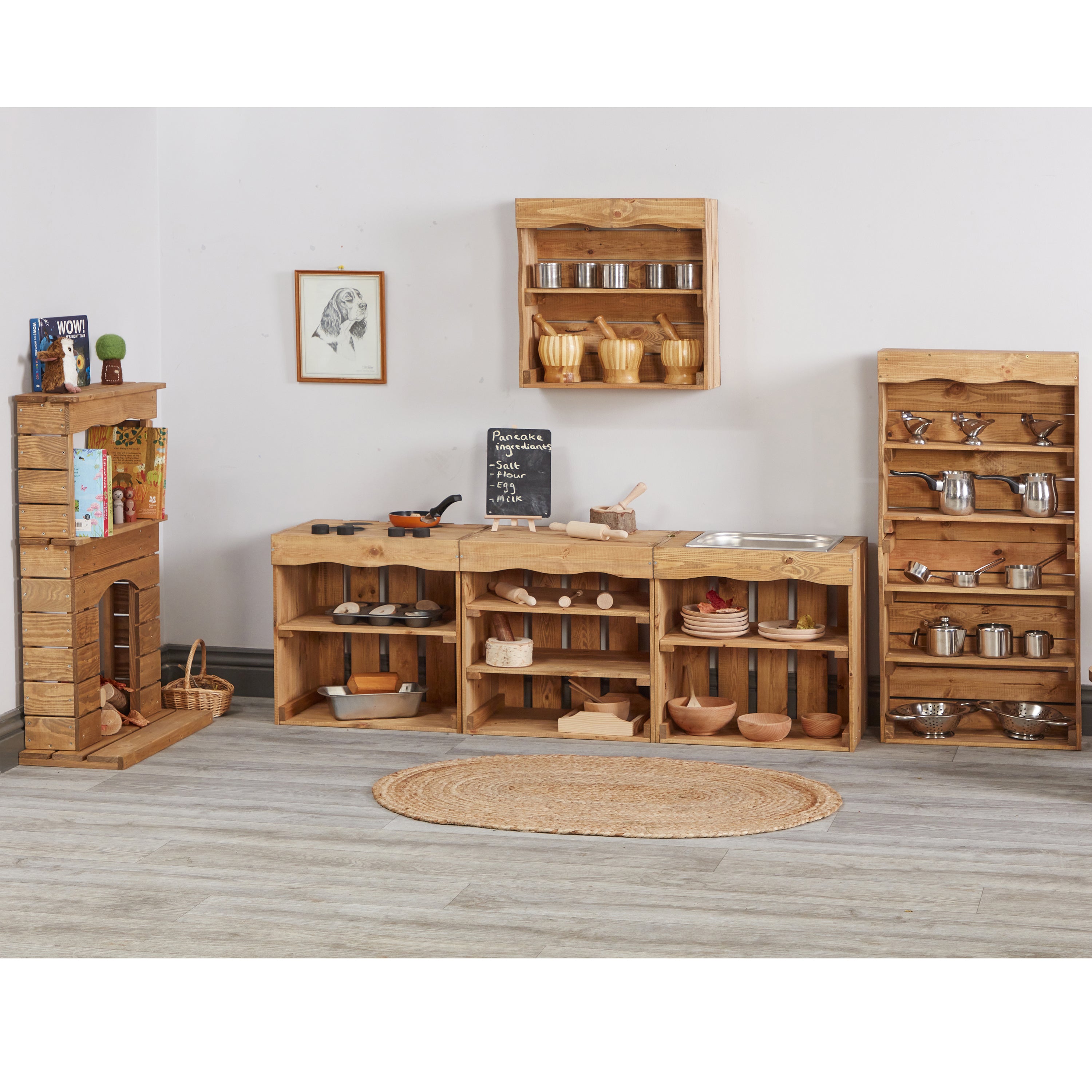 Wooden toy kitchen furniture set with shelves and cabinets in a room.