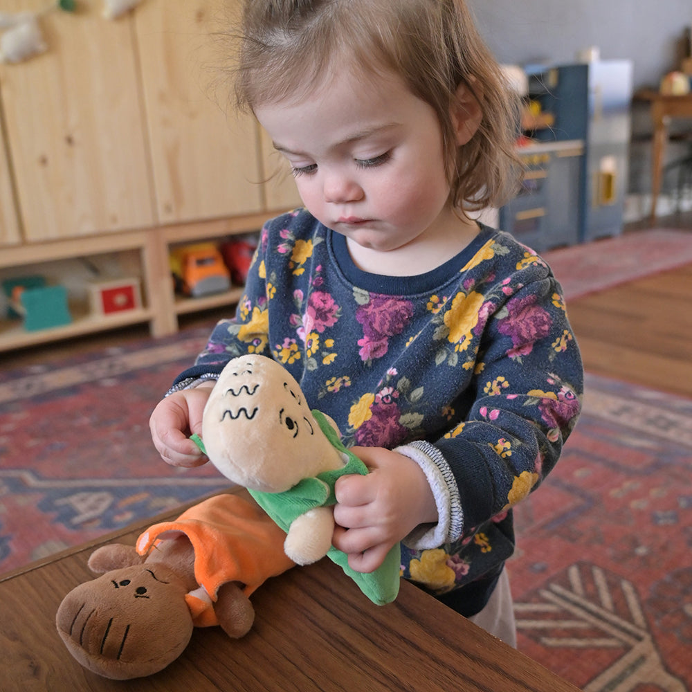 Toddler Removing Sleep Sack from Doll