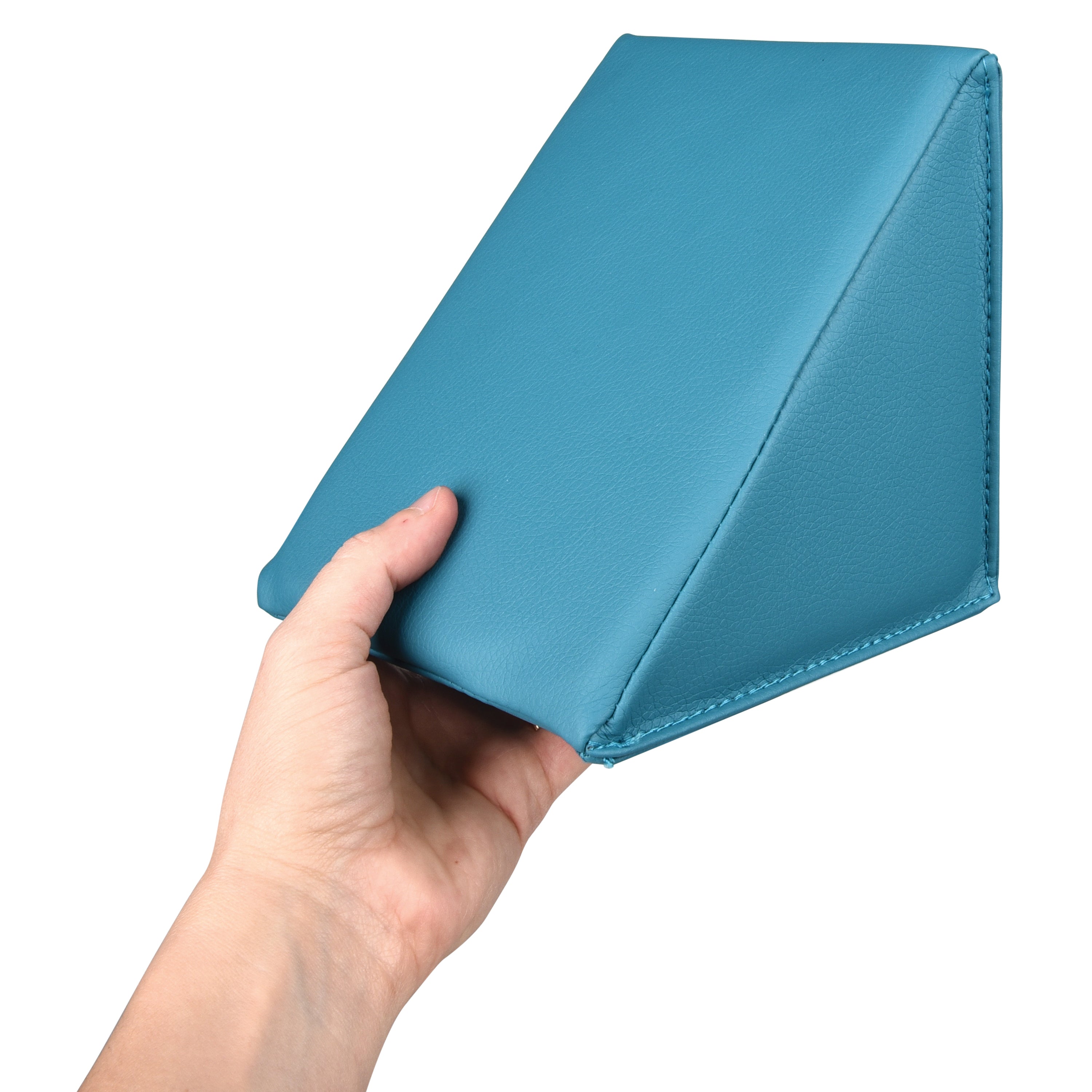 Hand holding a blue wedge-shaped object against a white background