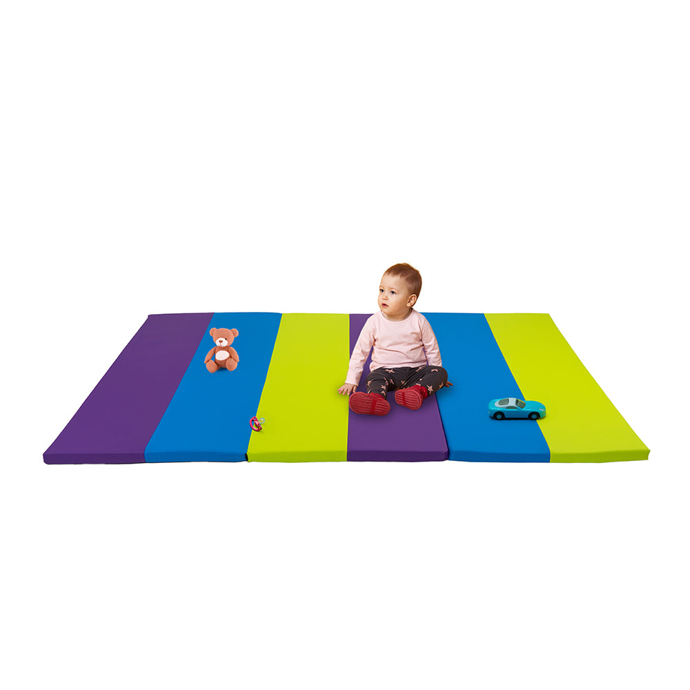 Colorful striped mat with a child sitting on it, surrounded by toys on a white background