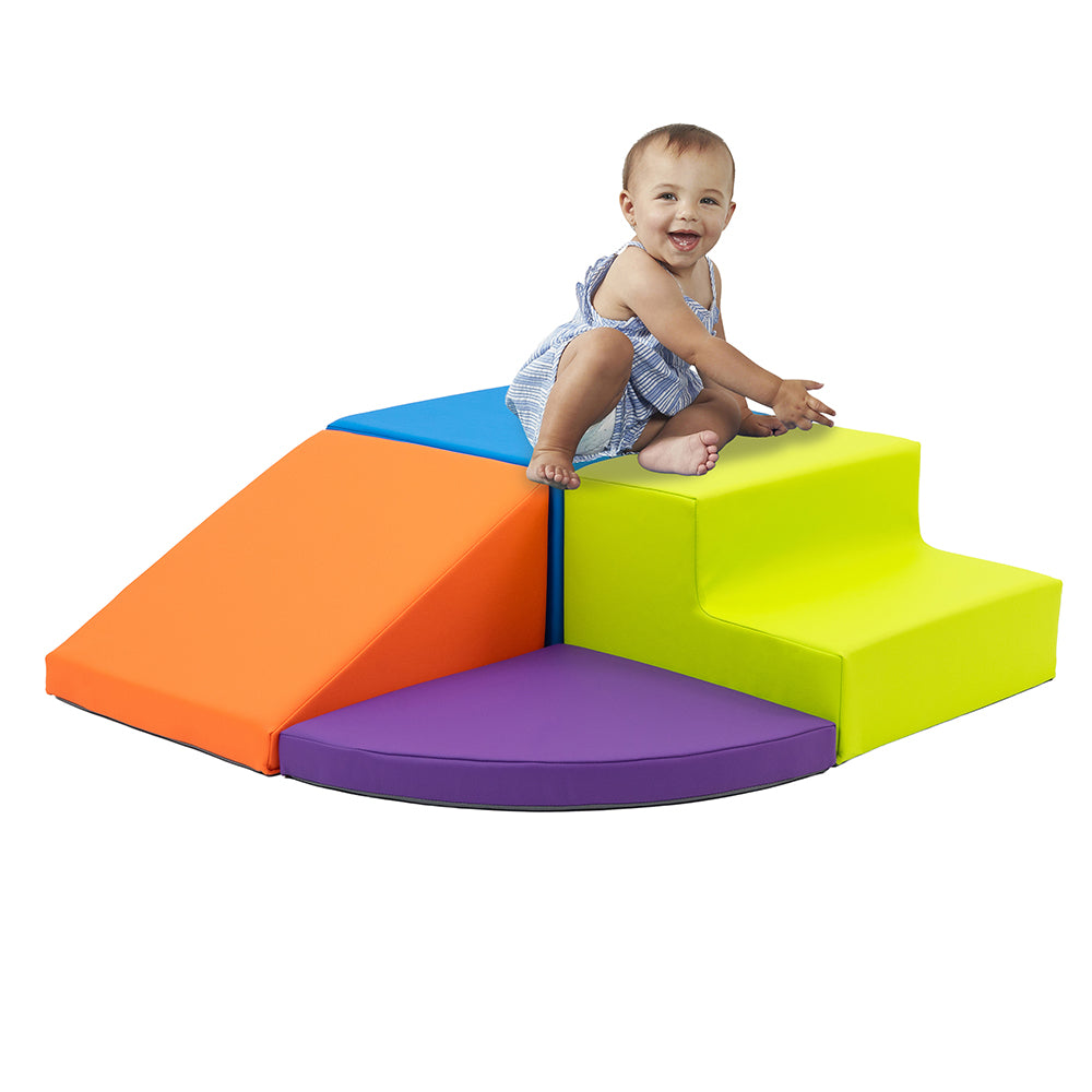 Child playing on a colorful foam play structure with steps on a white background