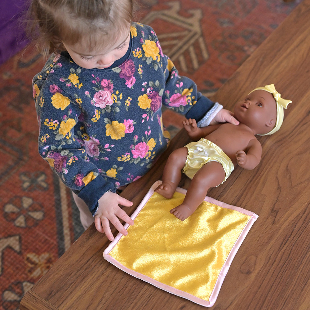 Toddler Playing with African American Baby Doll