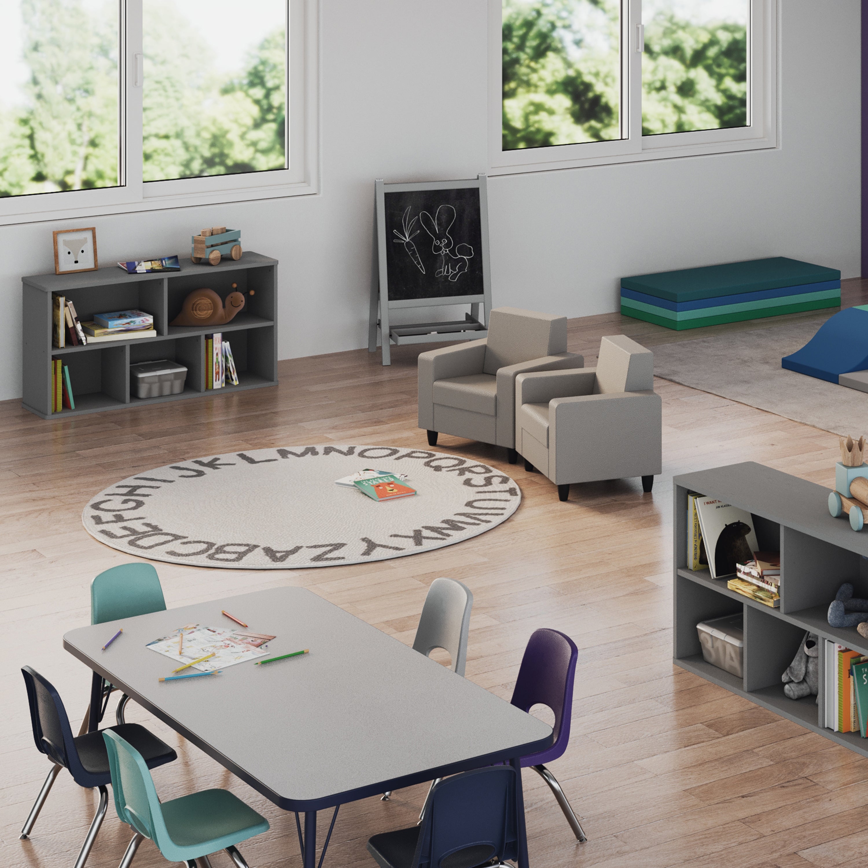 Children's classroom with a table, chairs, bookshelves, and educational materials.