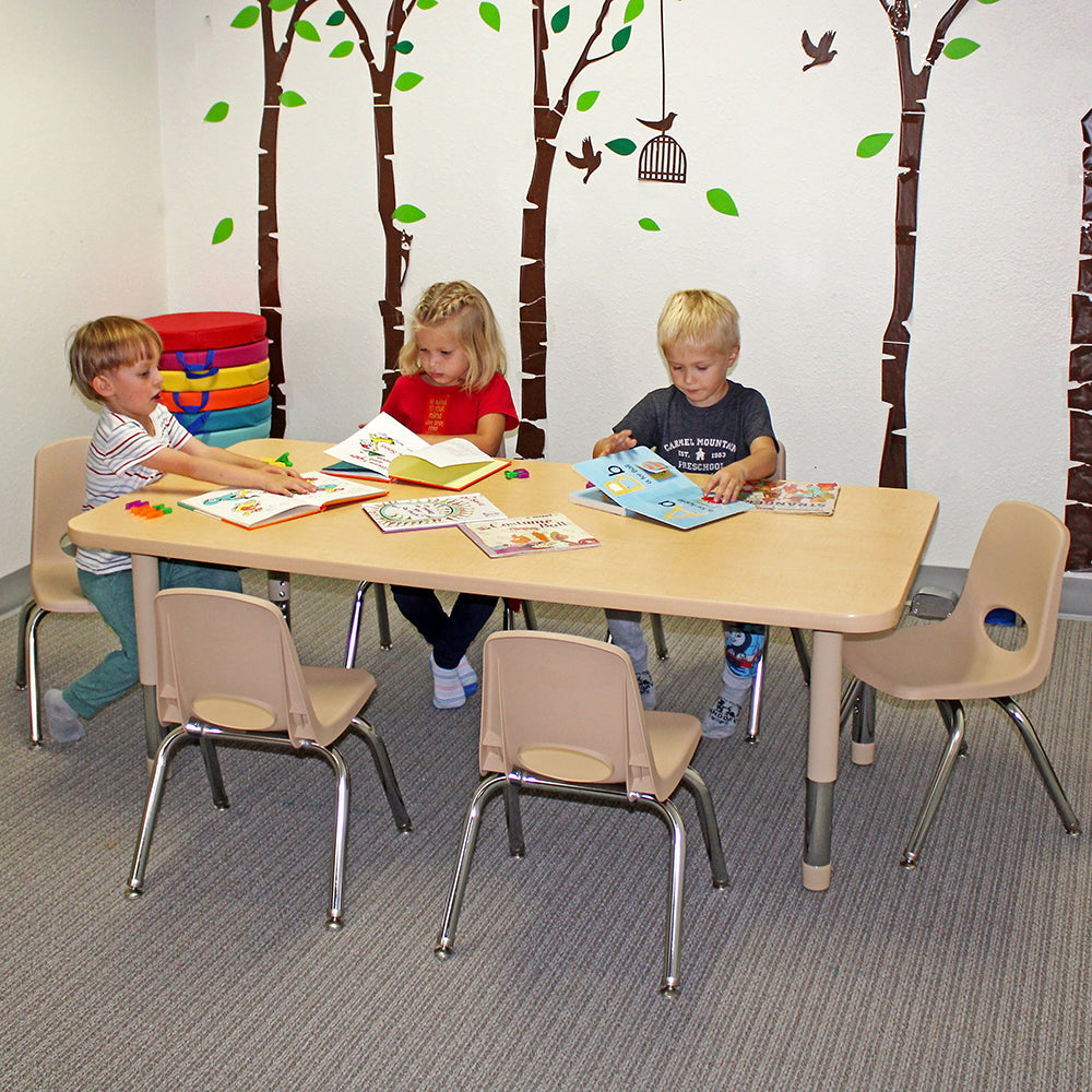 Children sitting around a table with educational materials in a classroom setting.