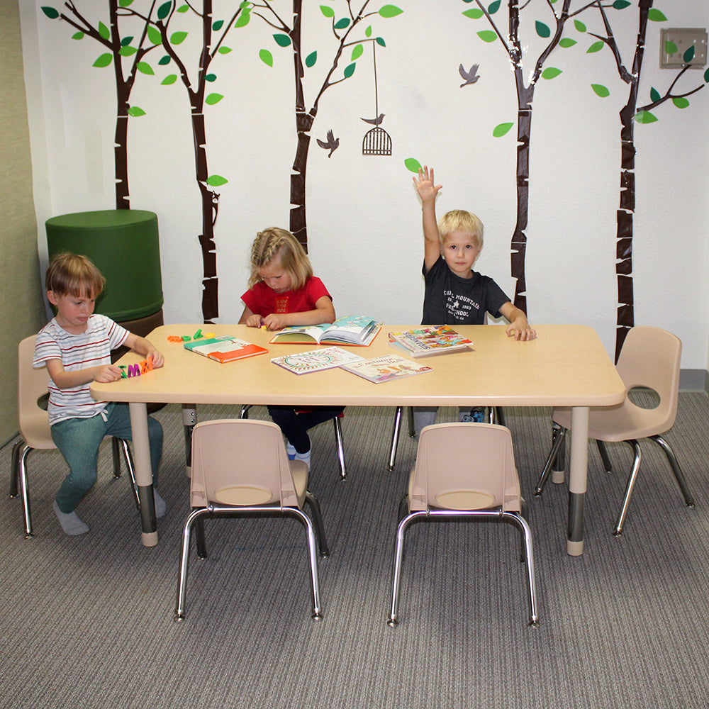 Children sitting around a table with educational materials in a classroom setting.