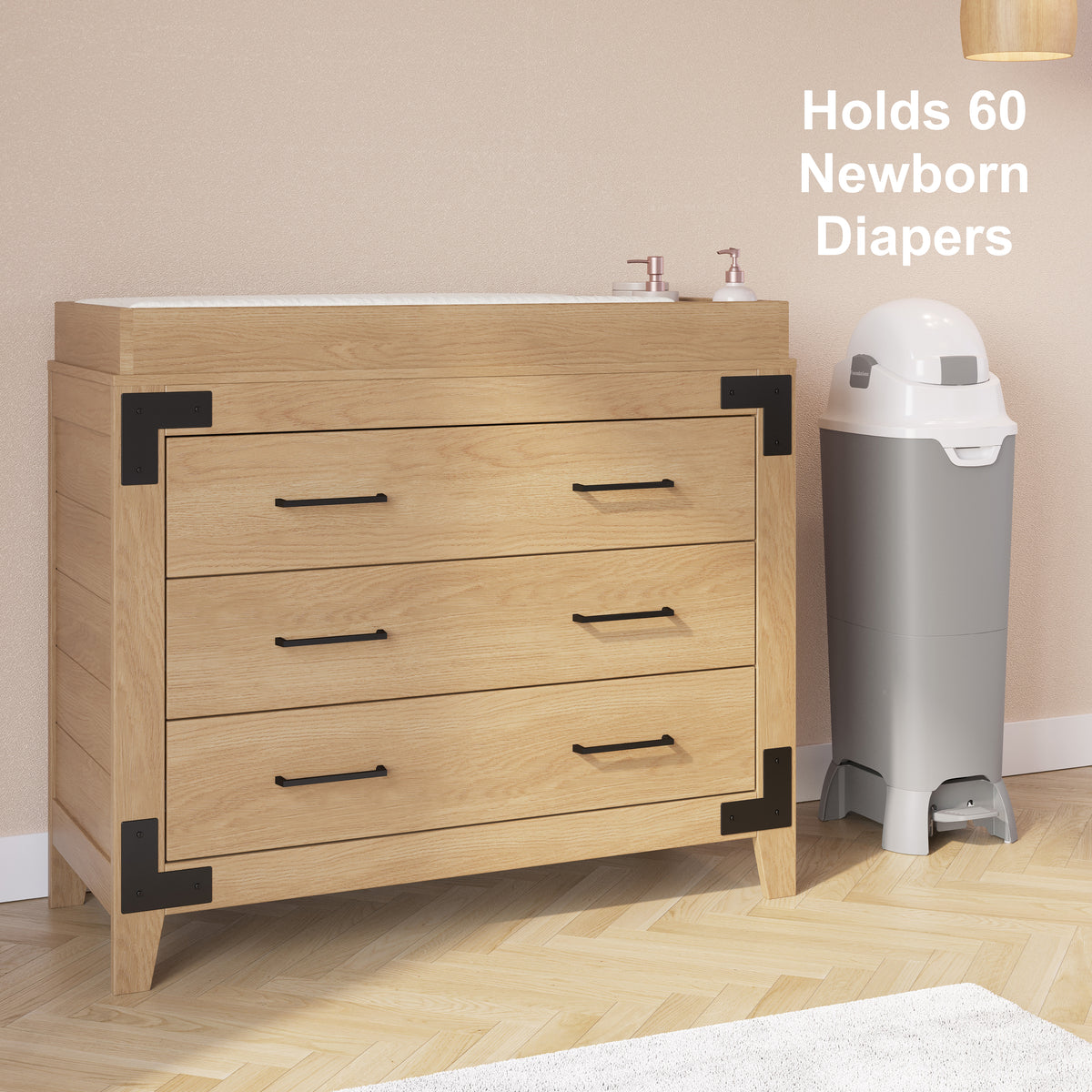 Tall diaper pail beside a changing table with capacity for up to 60 newborn diapers