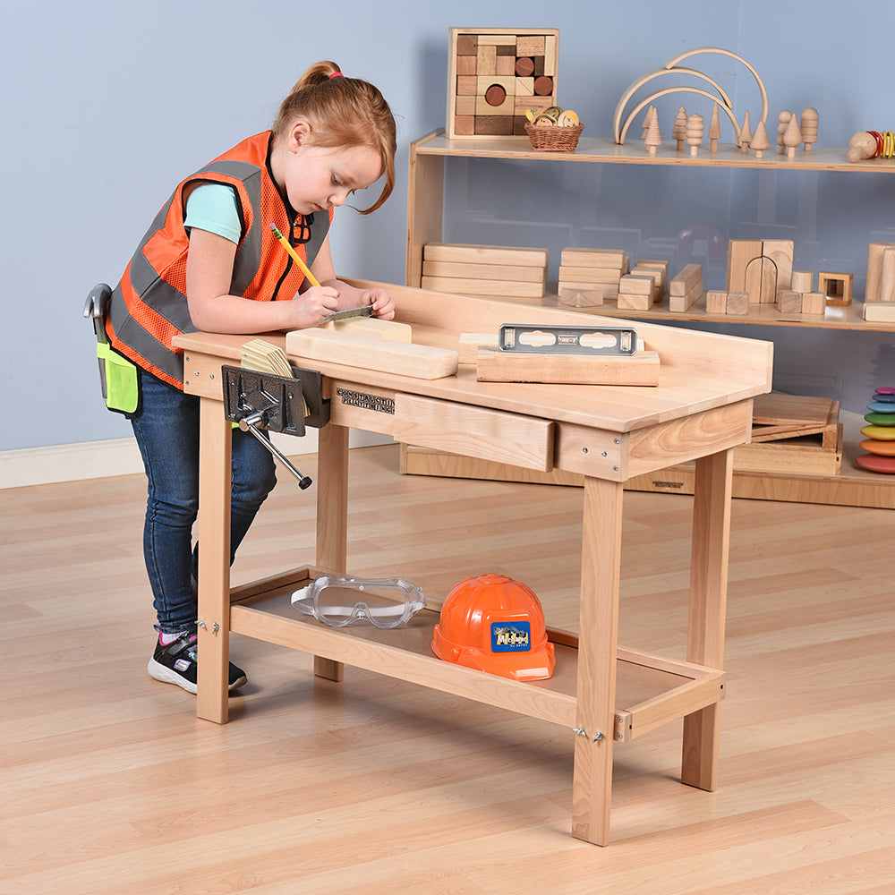 Kid Measuring Wood on Carpentry Workbench