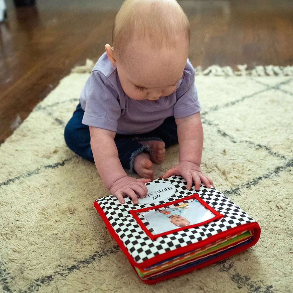Infant on Floor with Baby's First Photo Album