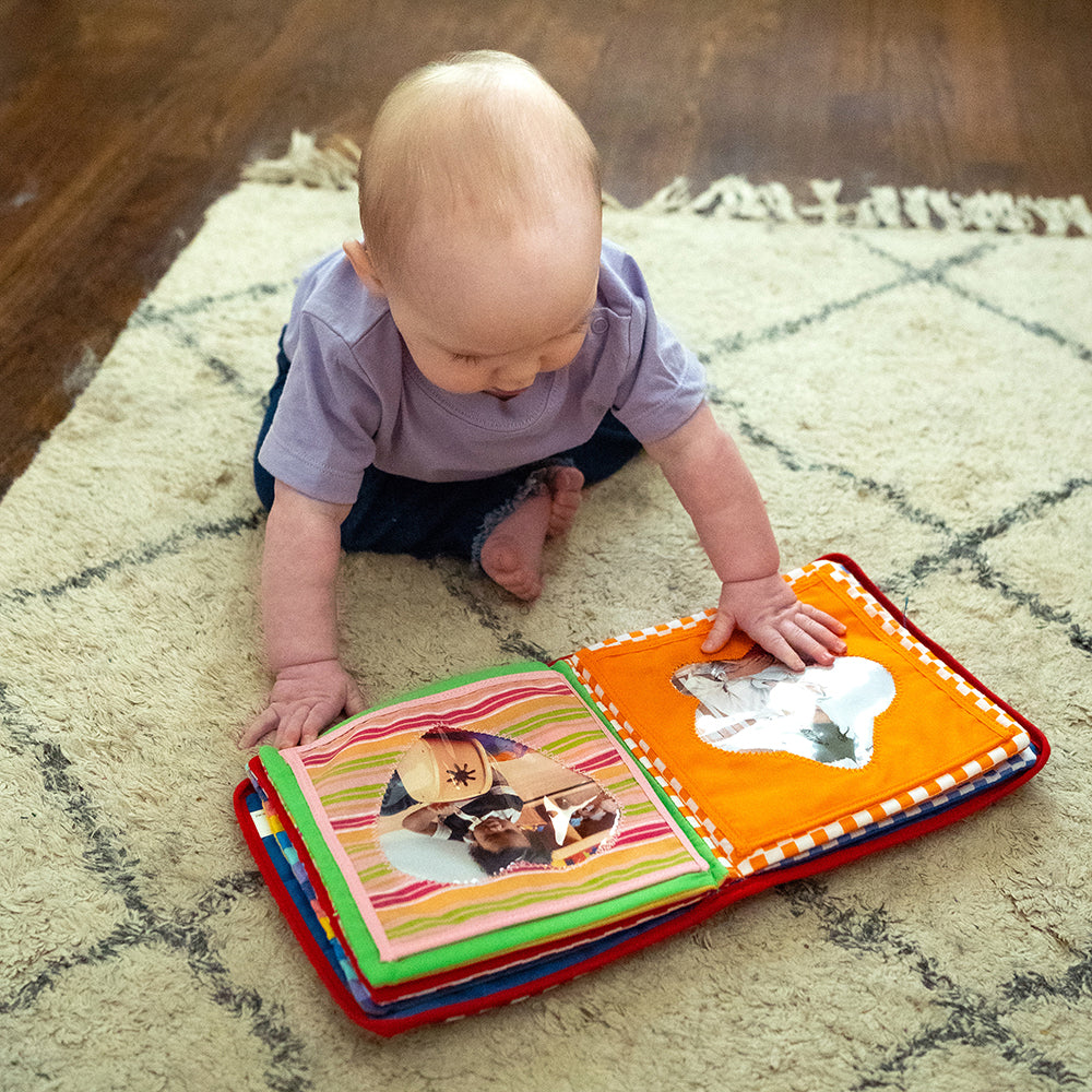 Infant Engaging with Baby's First Photo Album
