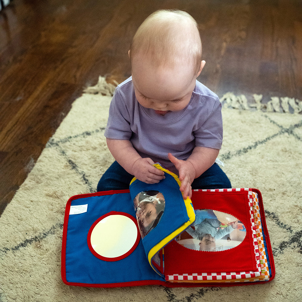 Baby Looking at Mirror in Baby's First Photo Album
