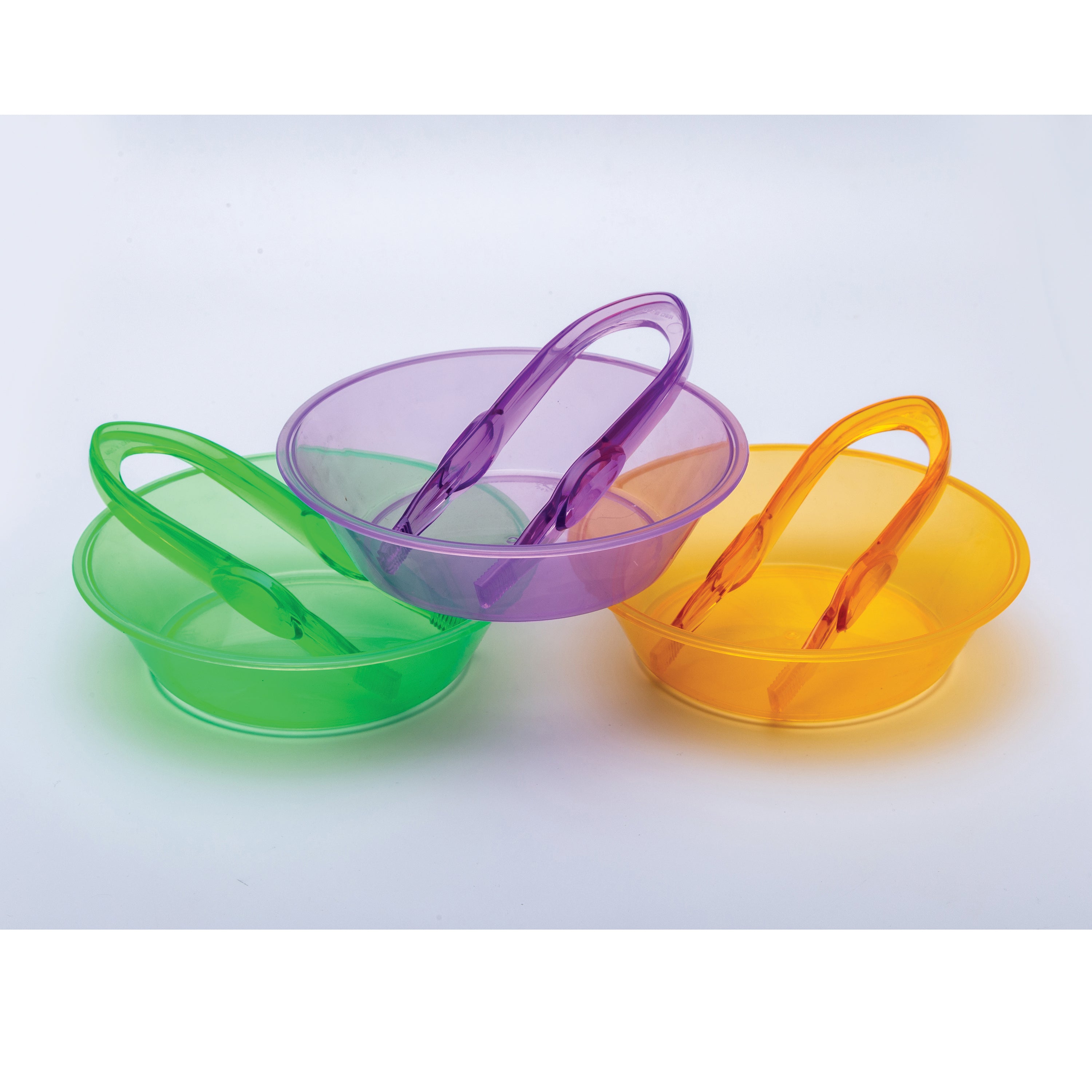 Three colorful plastic snack bowls with handles on a light gray background