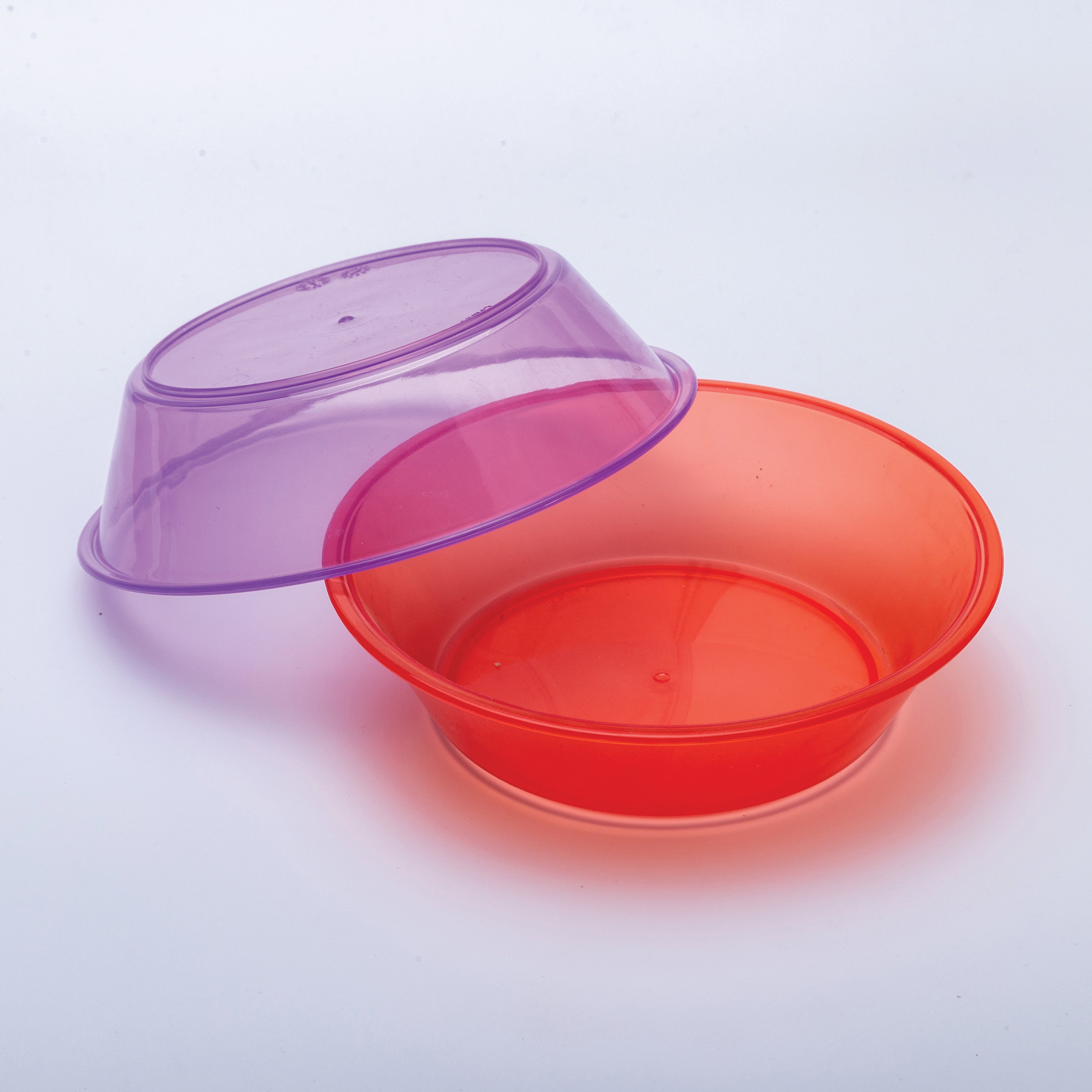 Red plastic bowl with a purple bowl on a light gray background