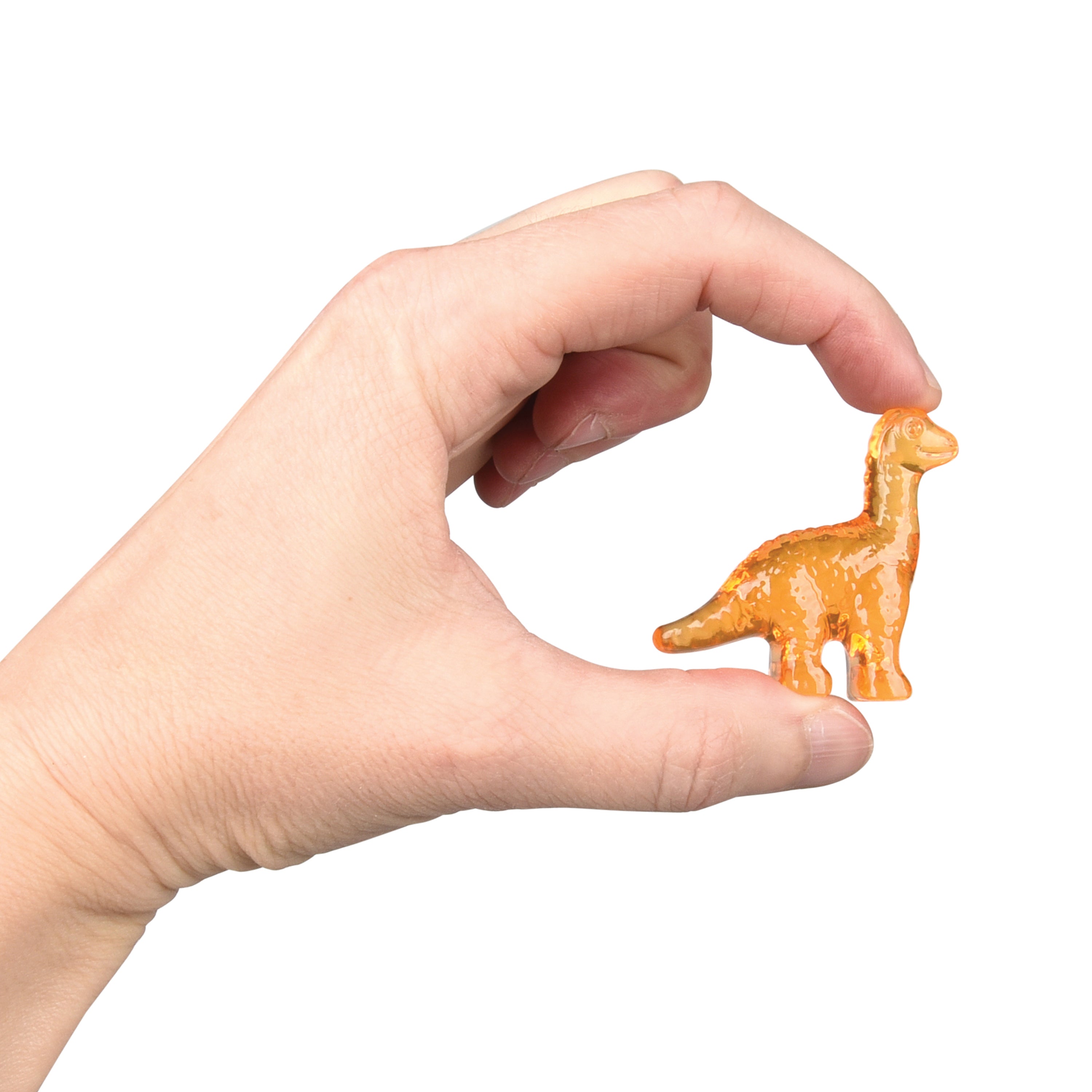 Hand holding a small orange dinosaur figurine against a white background