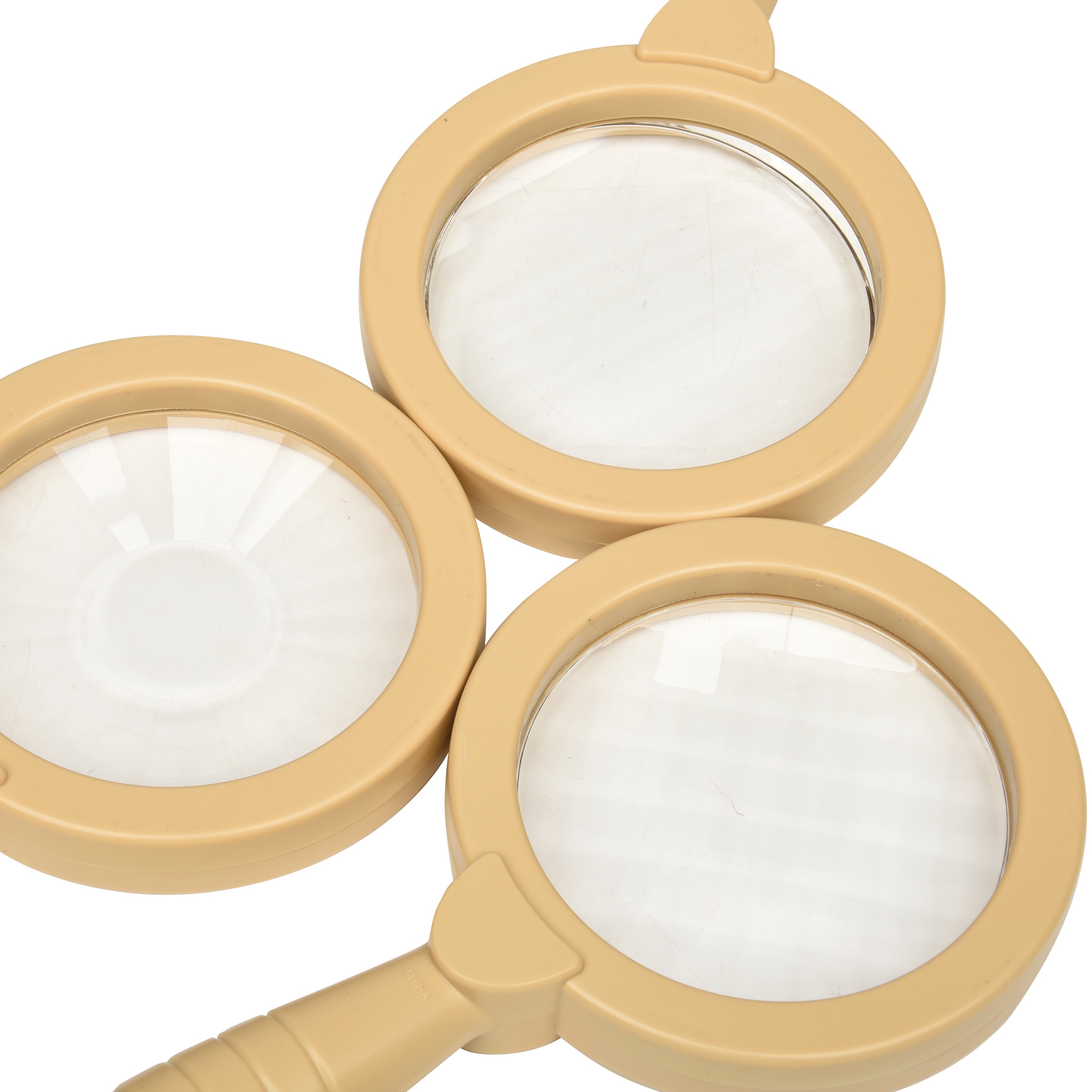 Three beige magnifying glasses with white lenses on a white background