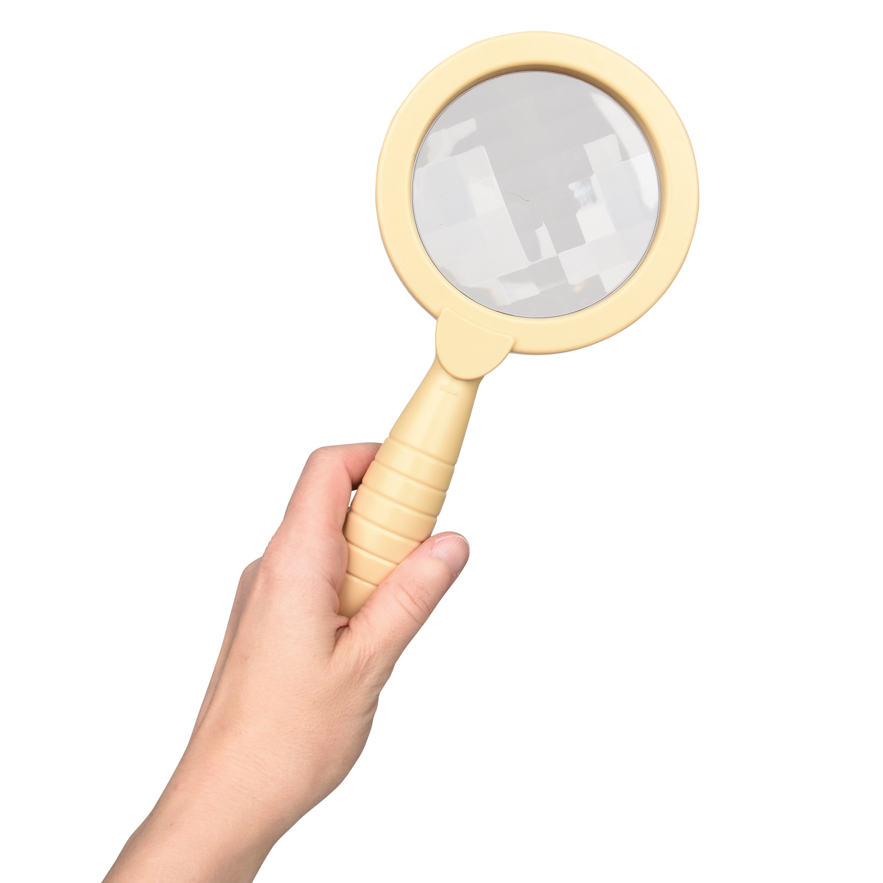 Hand holding a beige magnifying glass against a white background