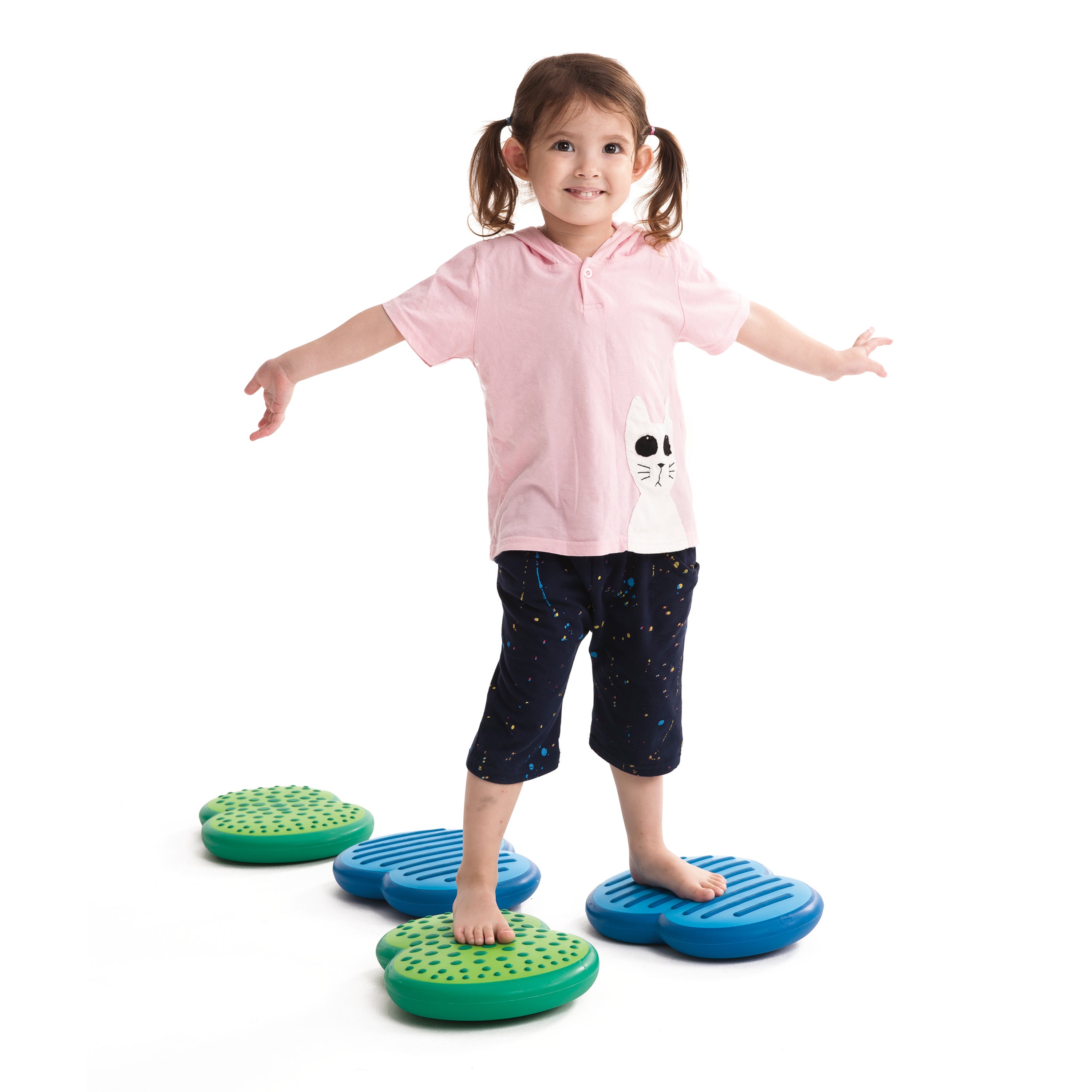 Child standing on a set of colorful stepping stones with a white background