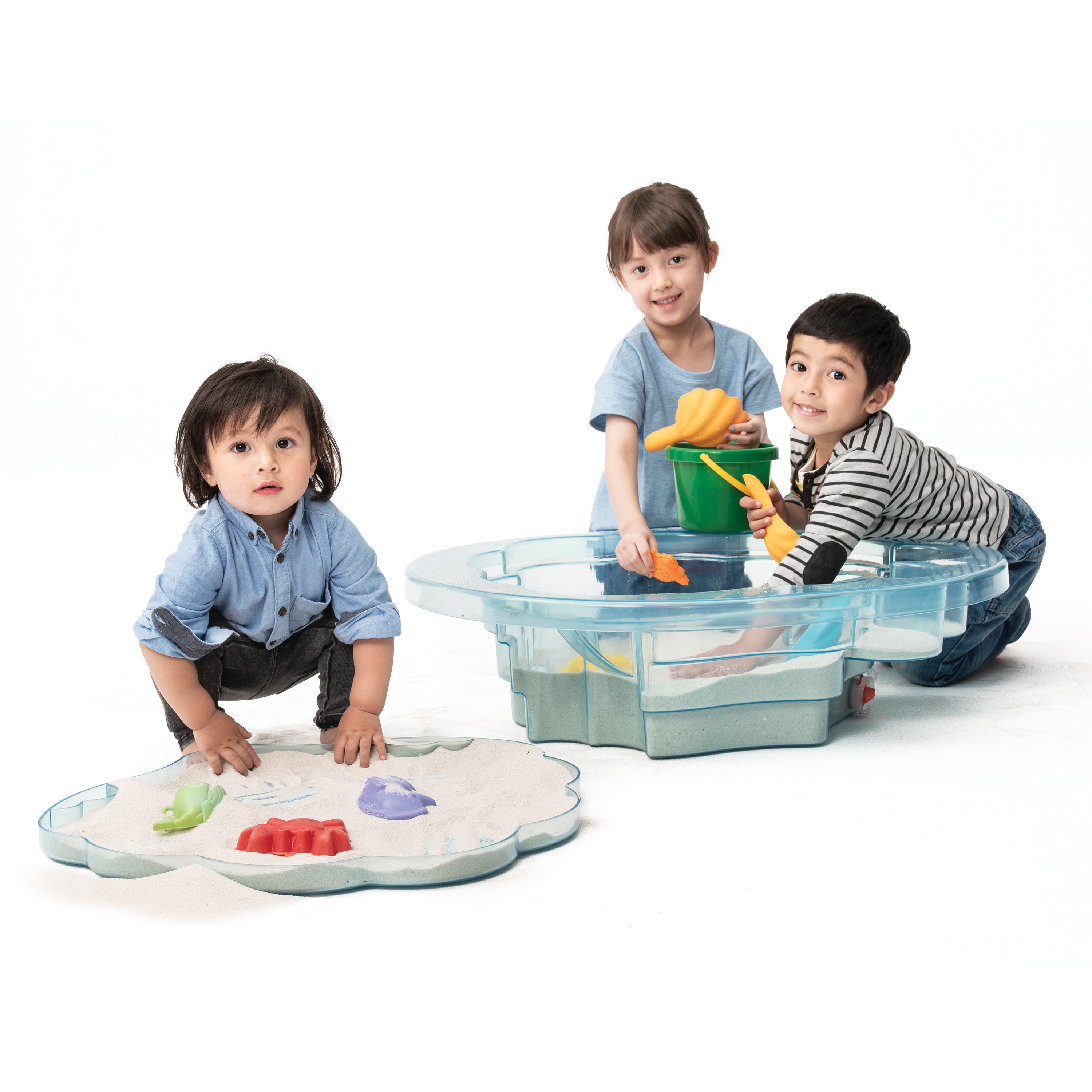 Three children playing with a sand table and toys on a white background