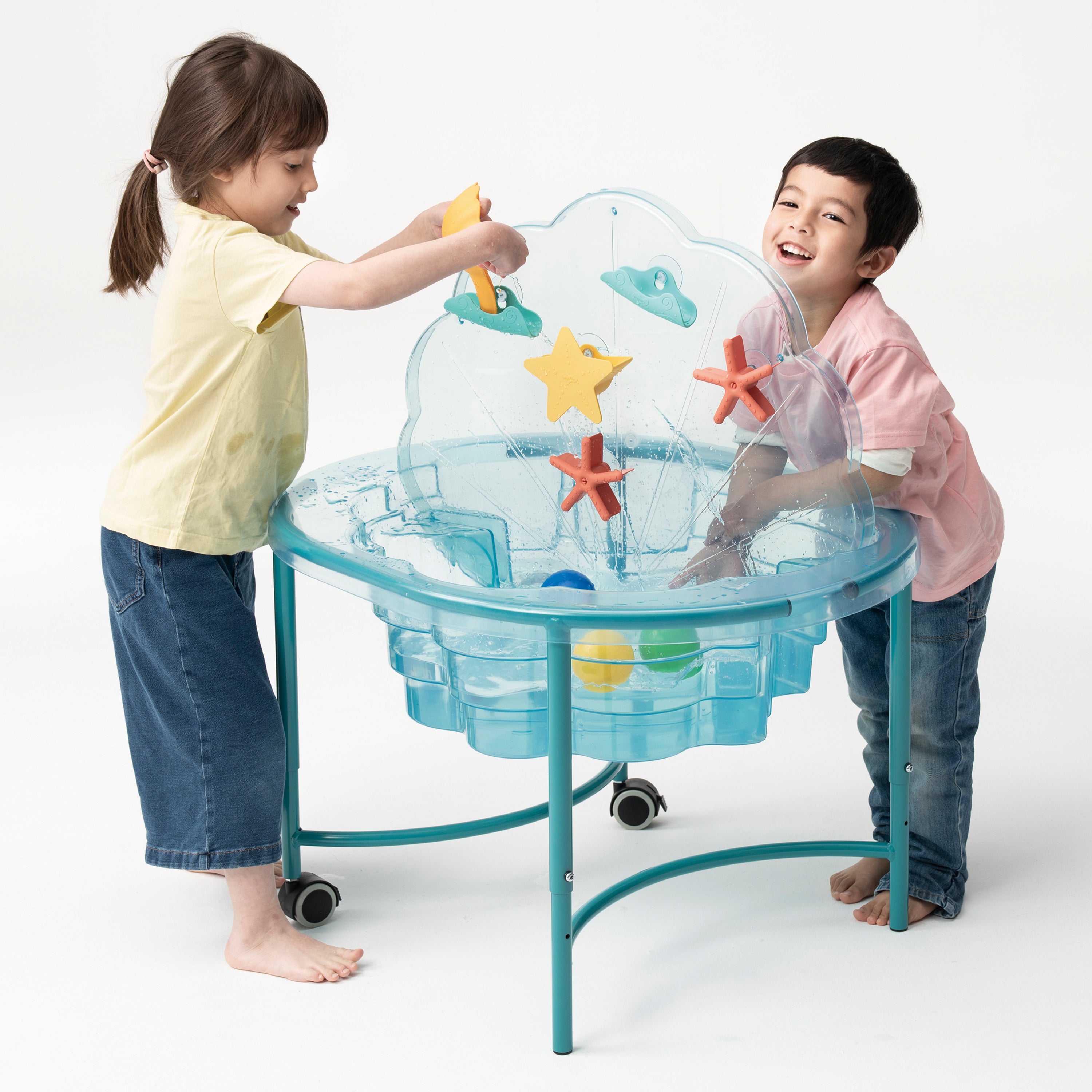 Two children playing with a transparent water table filled with colorful toys on a white background.