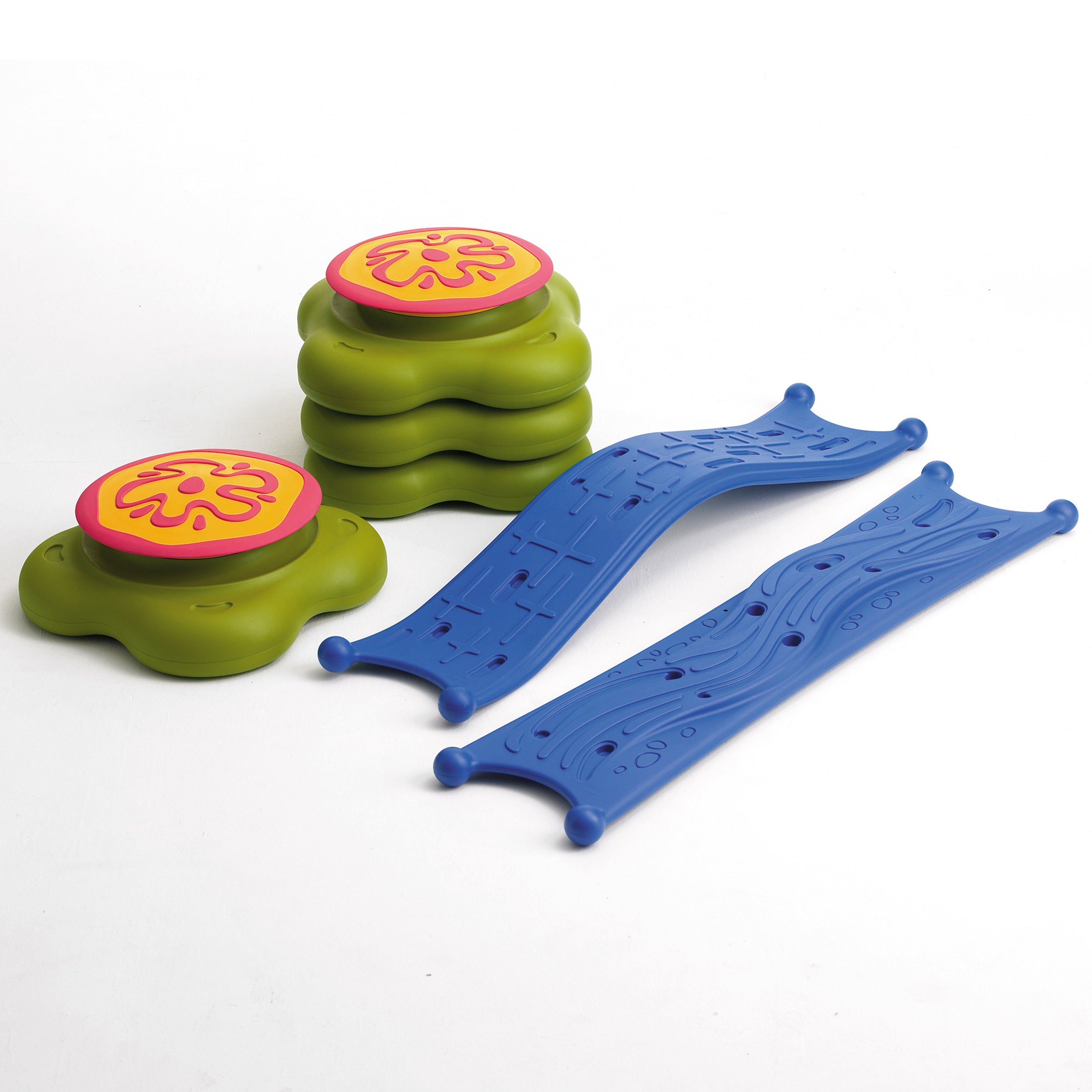 Colorful plastic toys including green cylindrical blocks with pink tops and blue ramps on a white background