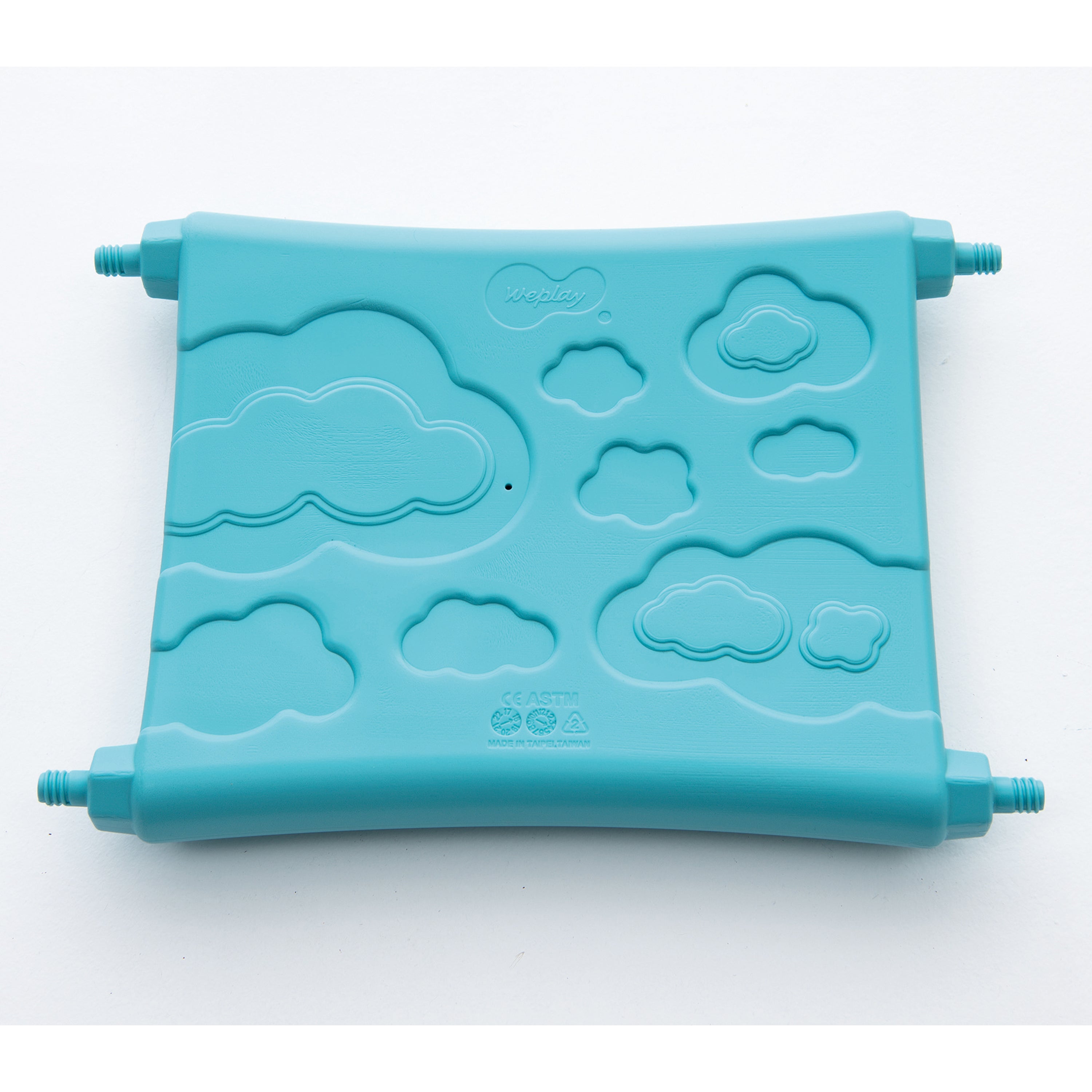 Turquoise plastic piece with cloud designs on a white background