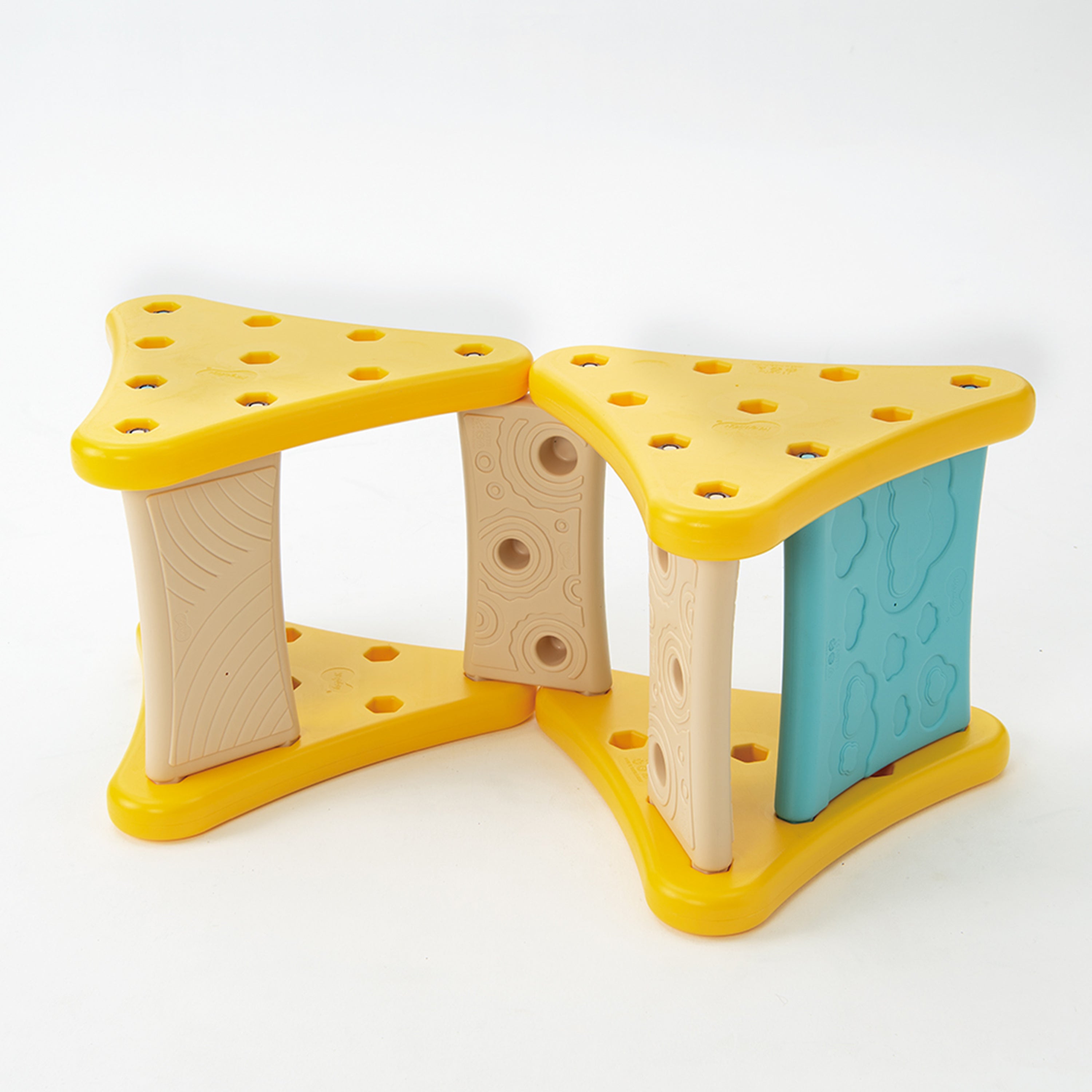 Yellow plastic toy structure with multiple holes on a white background