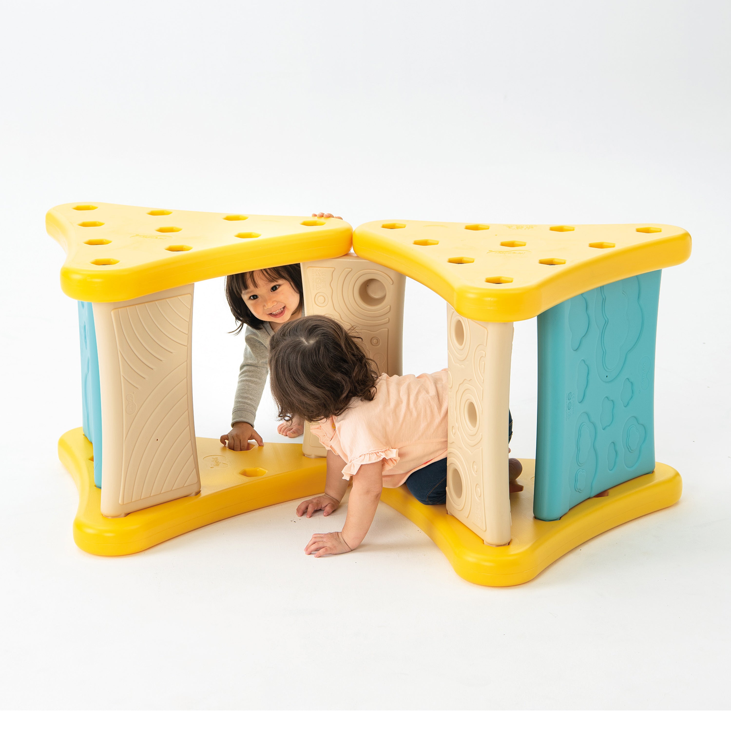 Children playing with a colorful play structure on a white background