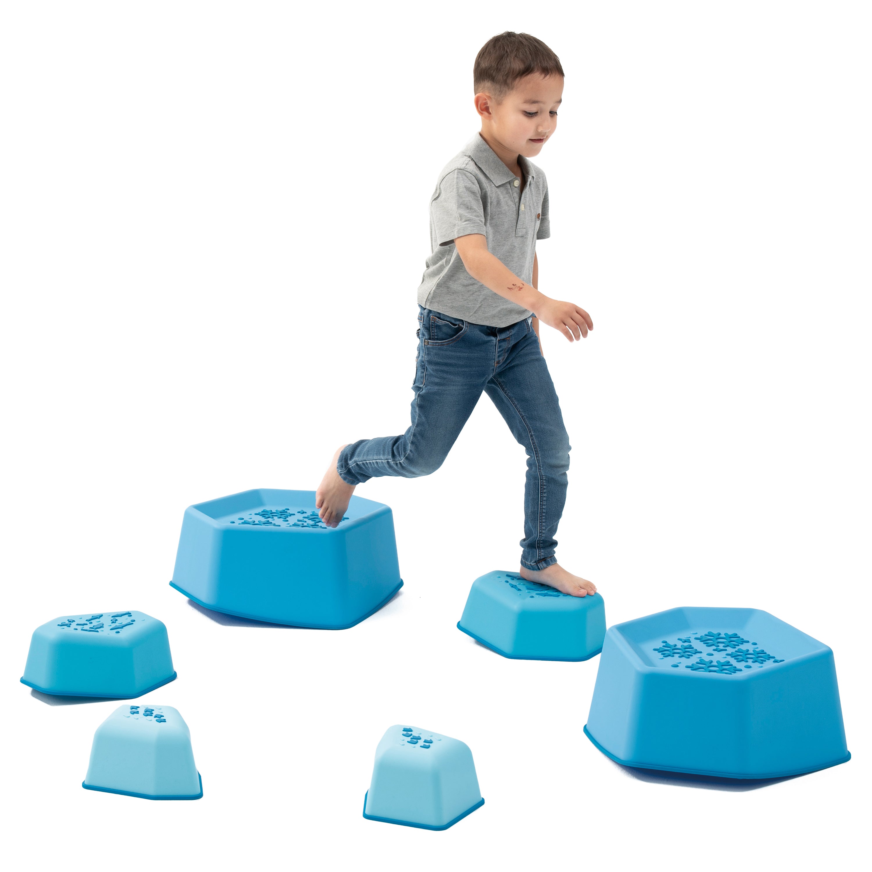 Child playing with blue stepping stones on a white background