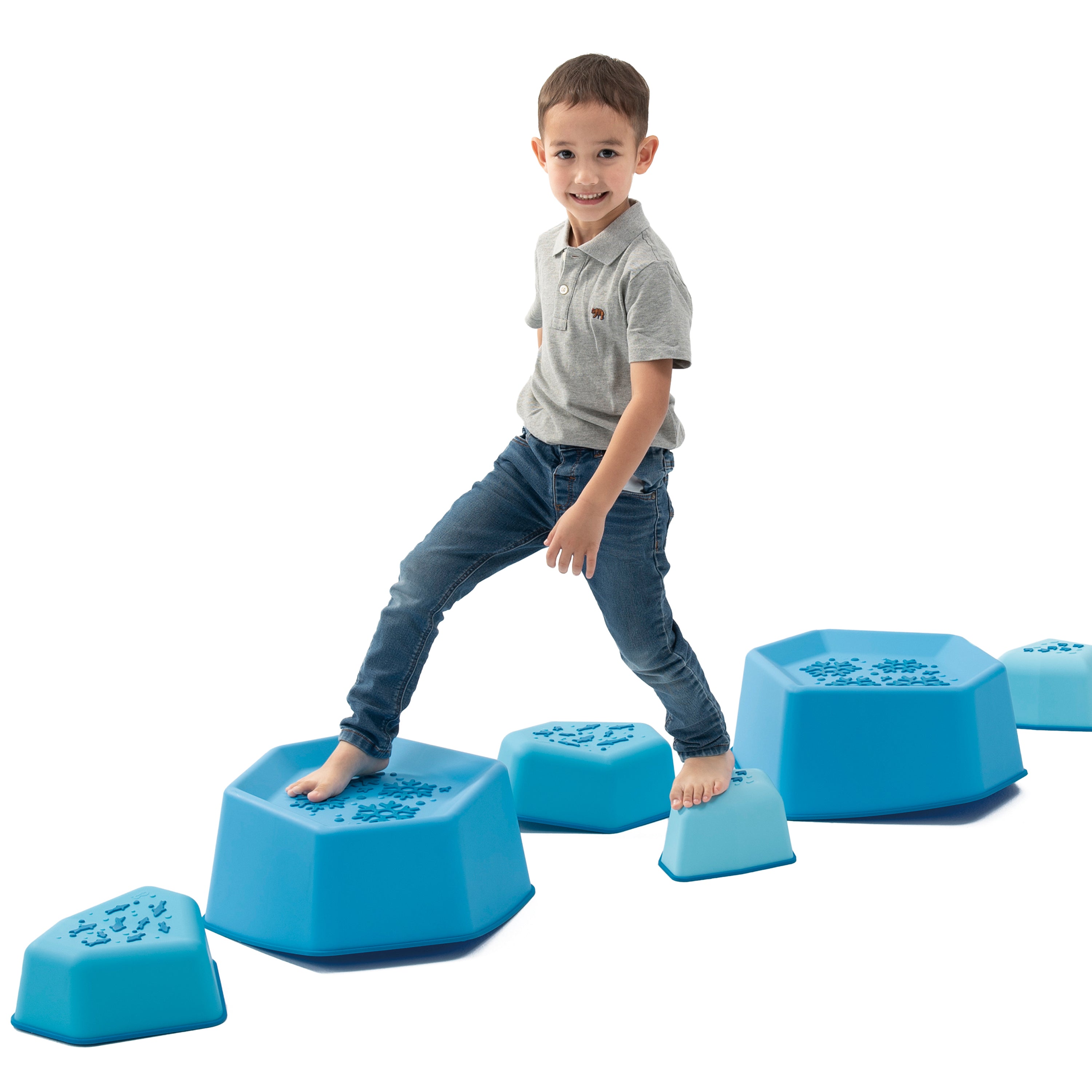 Child playing with blue stepping stones on a white background