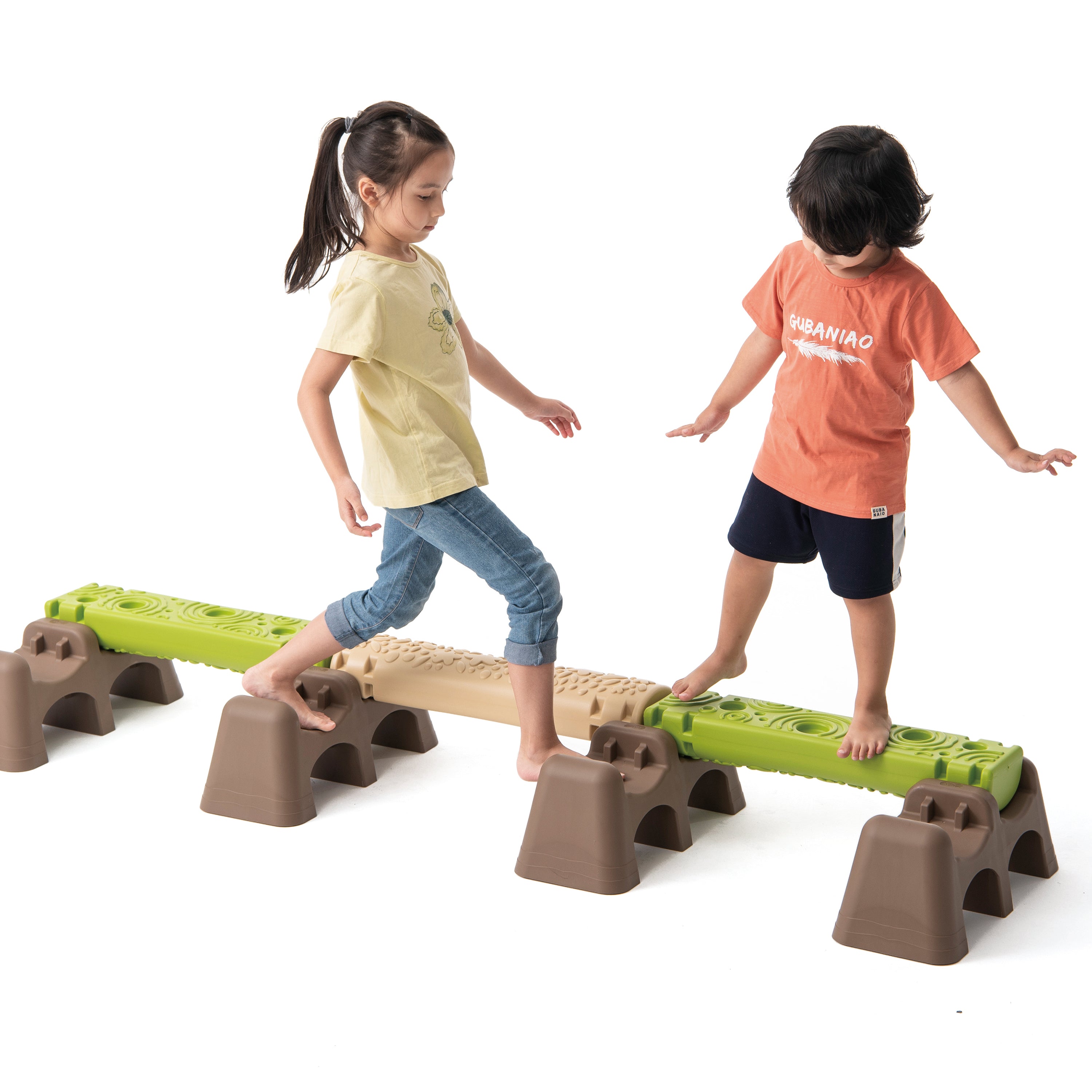 Two children playing on a set of playground balance beams.