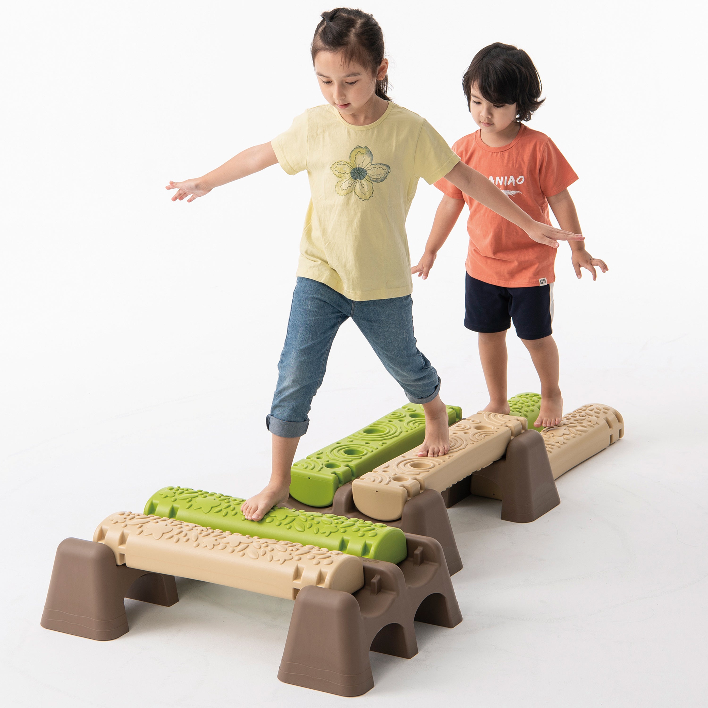 Two children playing on a set of interlocking steps with green and brown colors.