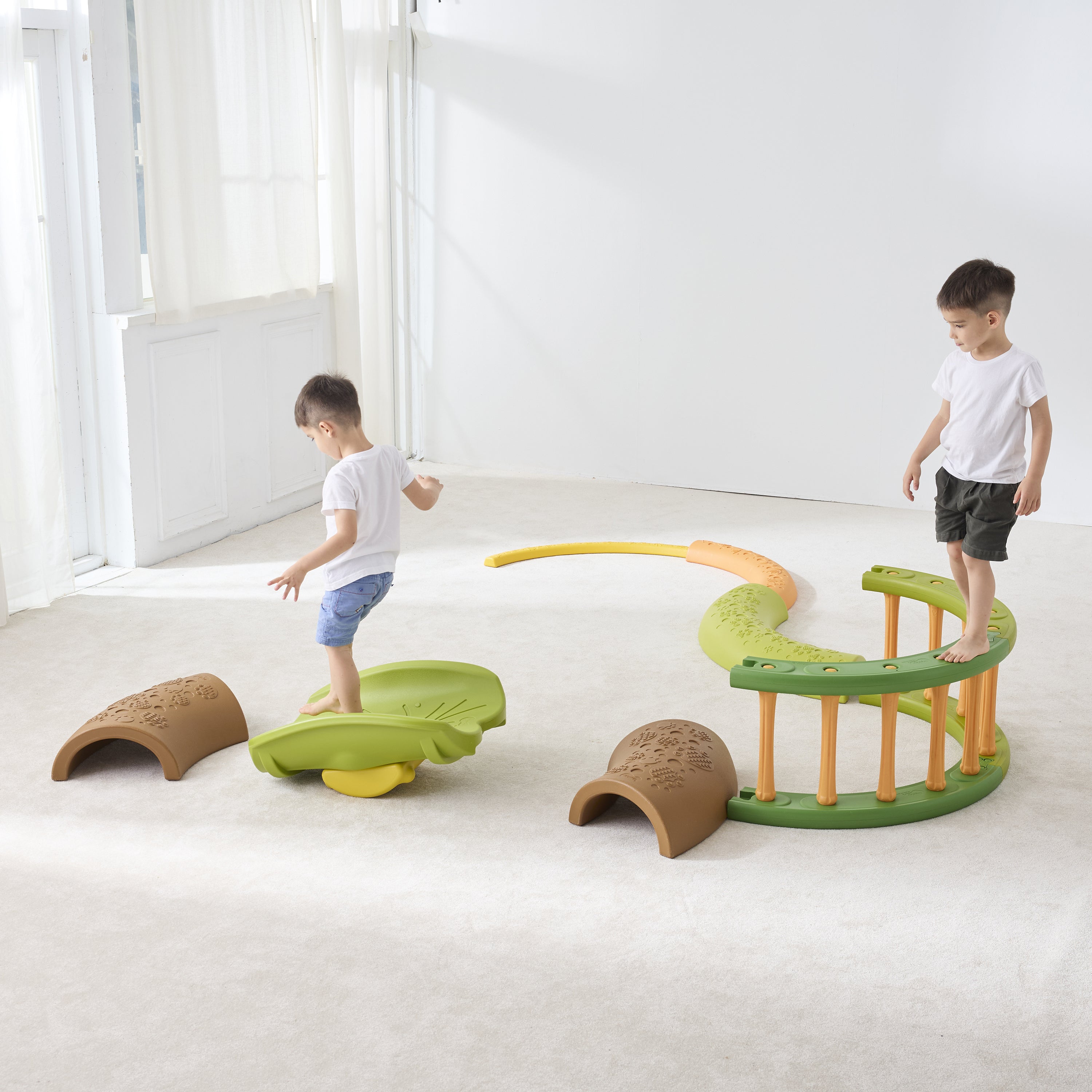 Children playing on a colorful indoor play structure in a bright room.