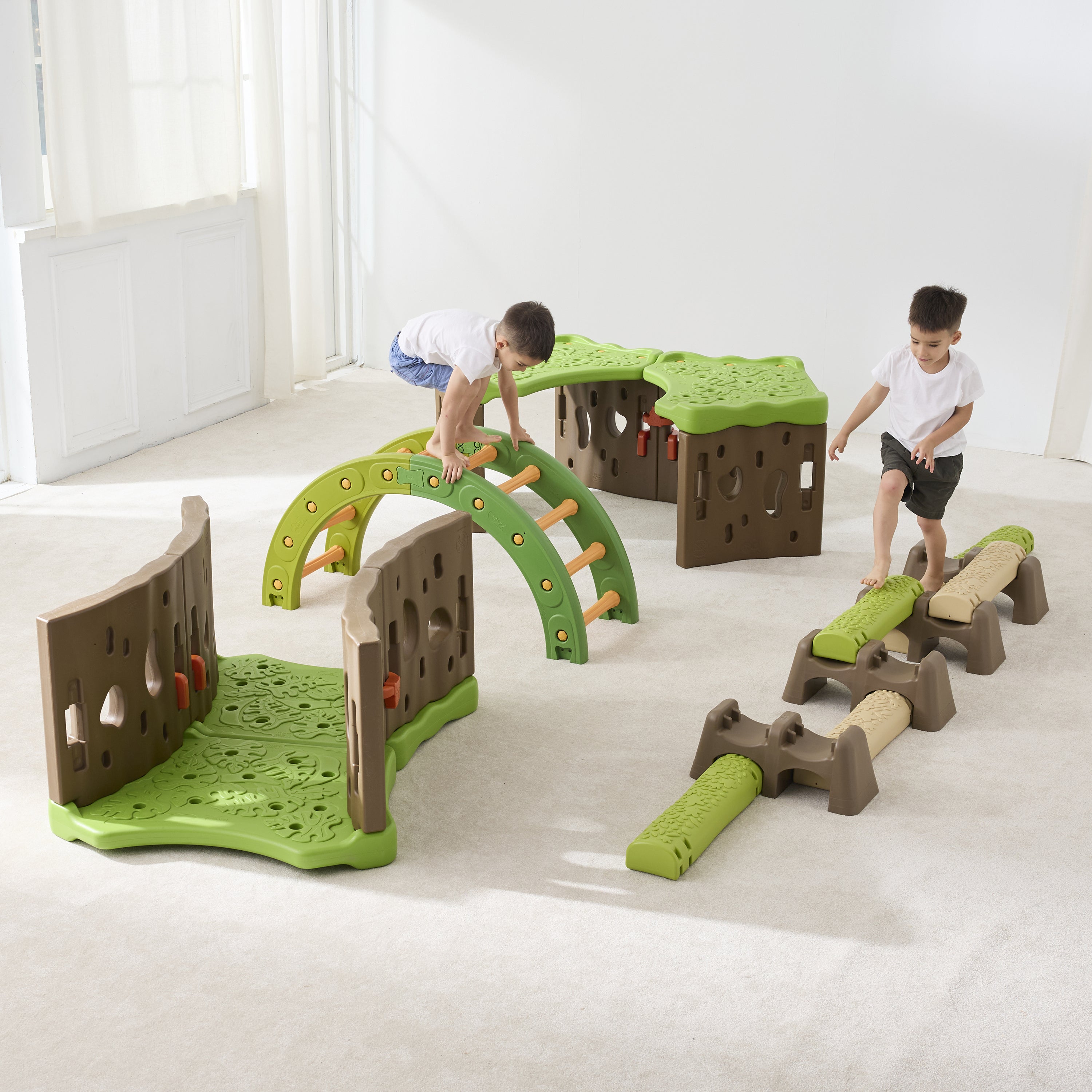 Children playing with a green and brown play structure on a white floor.