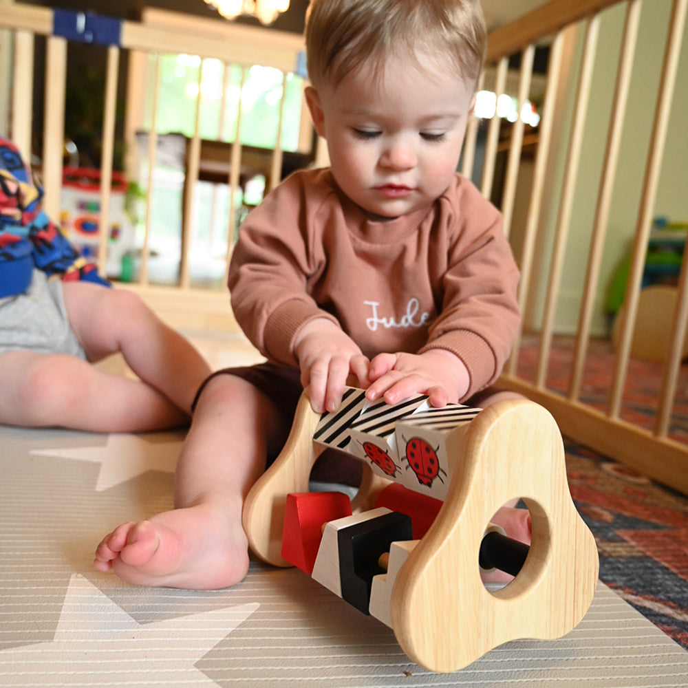 Toddler Playing with Busy Box Activity Toy