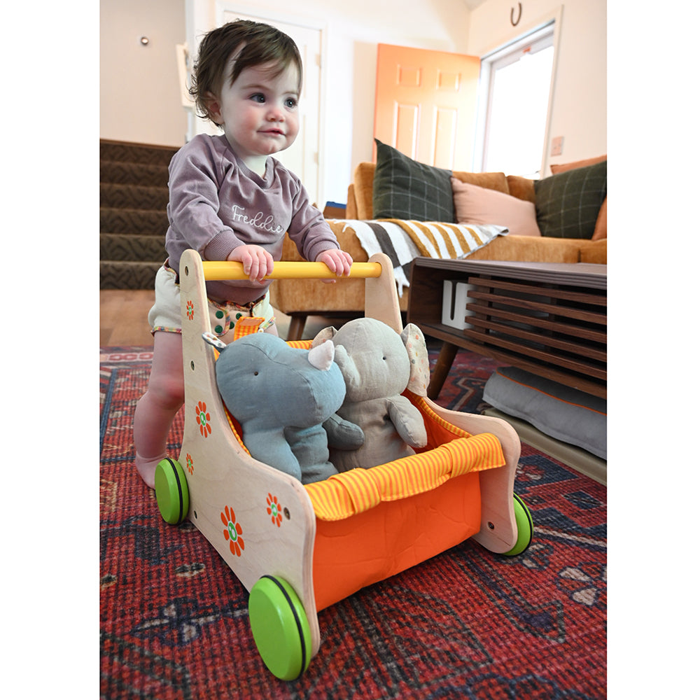Baby Pushing Stuffed Animals in Beginner's Buggy