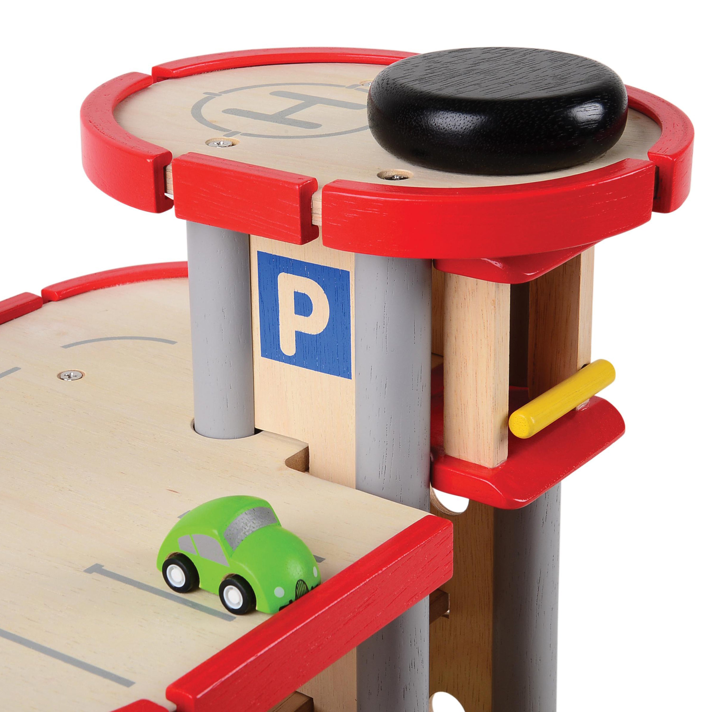 Wooden toy parking garage with a green car on a white background