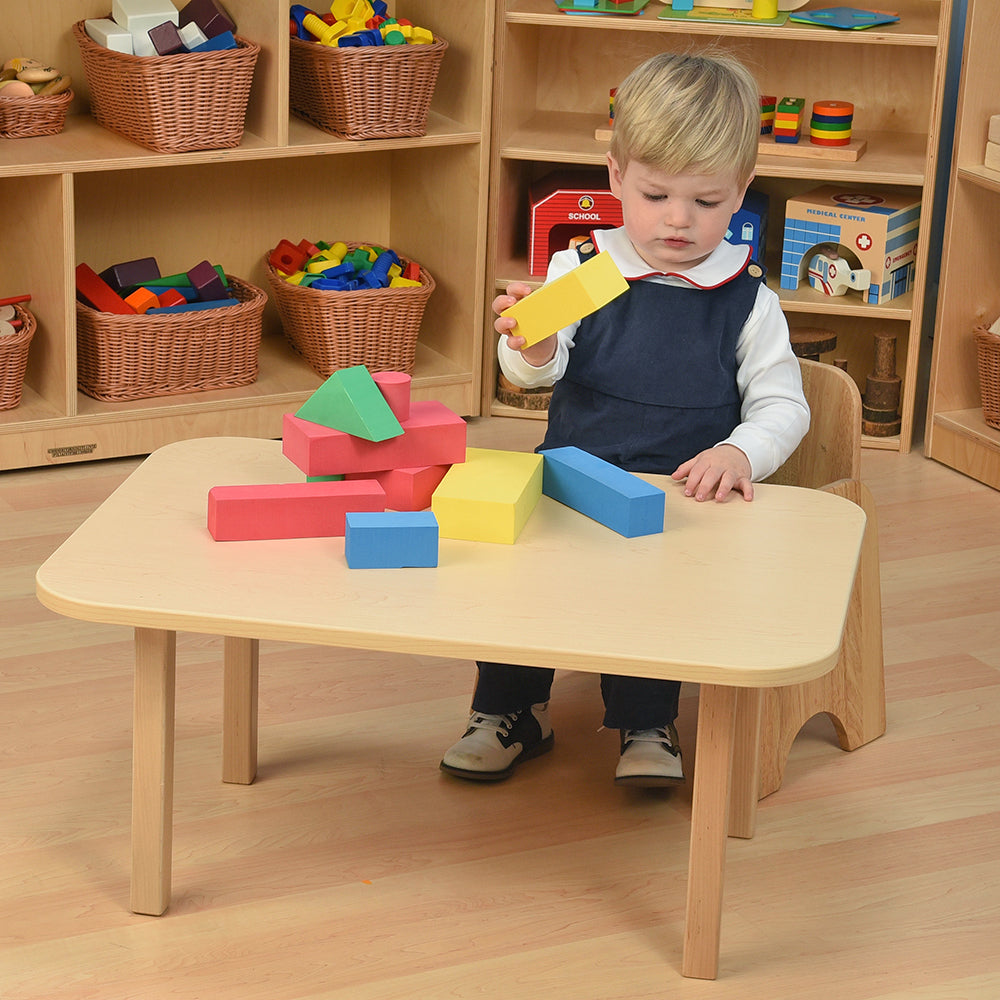 Toddler Seated at Classic Hardwood Toddler Table in the Classroom