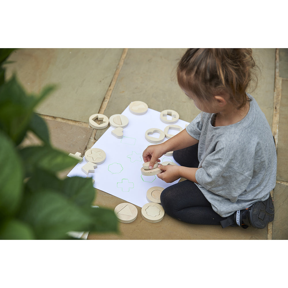 Tracing shapes with Inside Outside Wooden Shapes