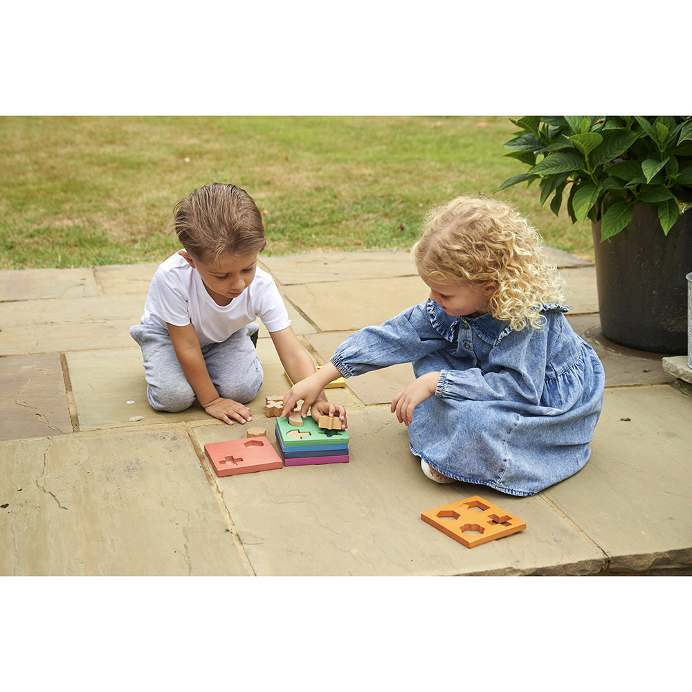 Two Kids Exploring Wooden Shapes