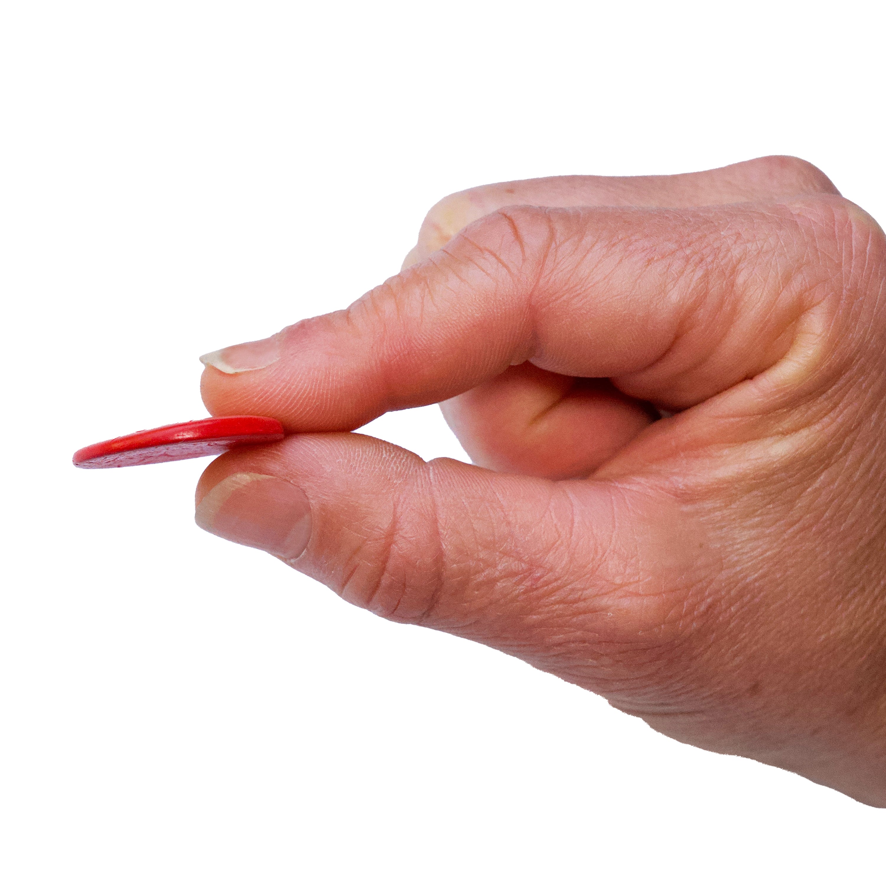 Hand holding a thin button between 2 fingers on a white background