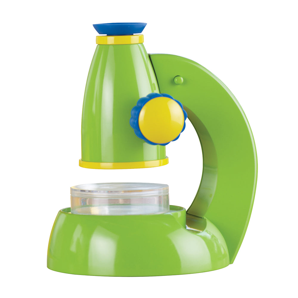 Green and yellow toy microscope on a white background