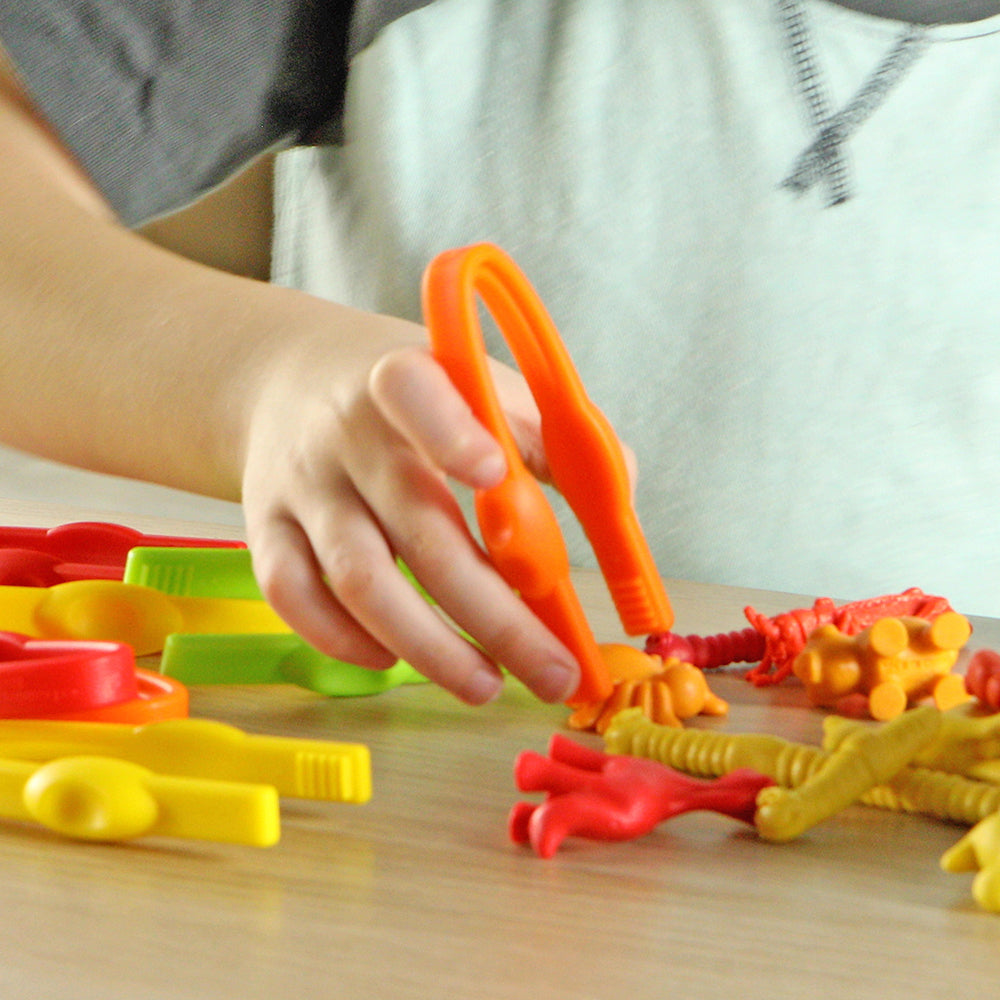 Kid Using Orange Easy Grip Tweezers